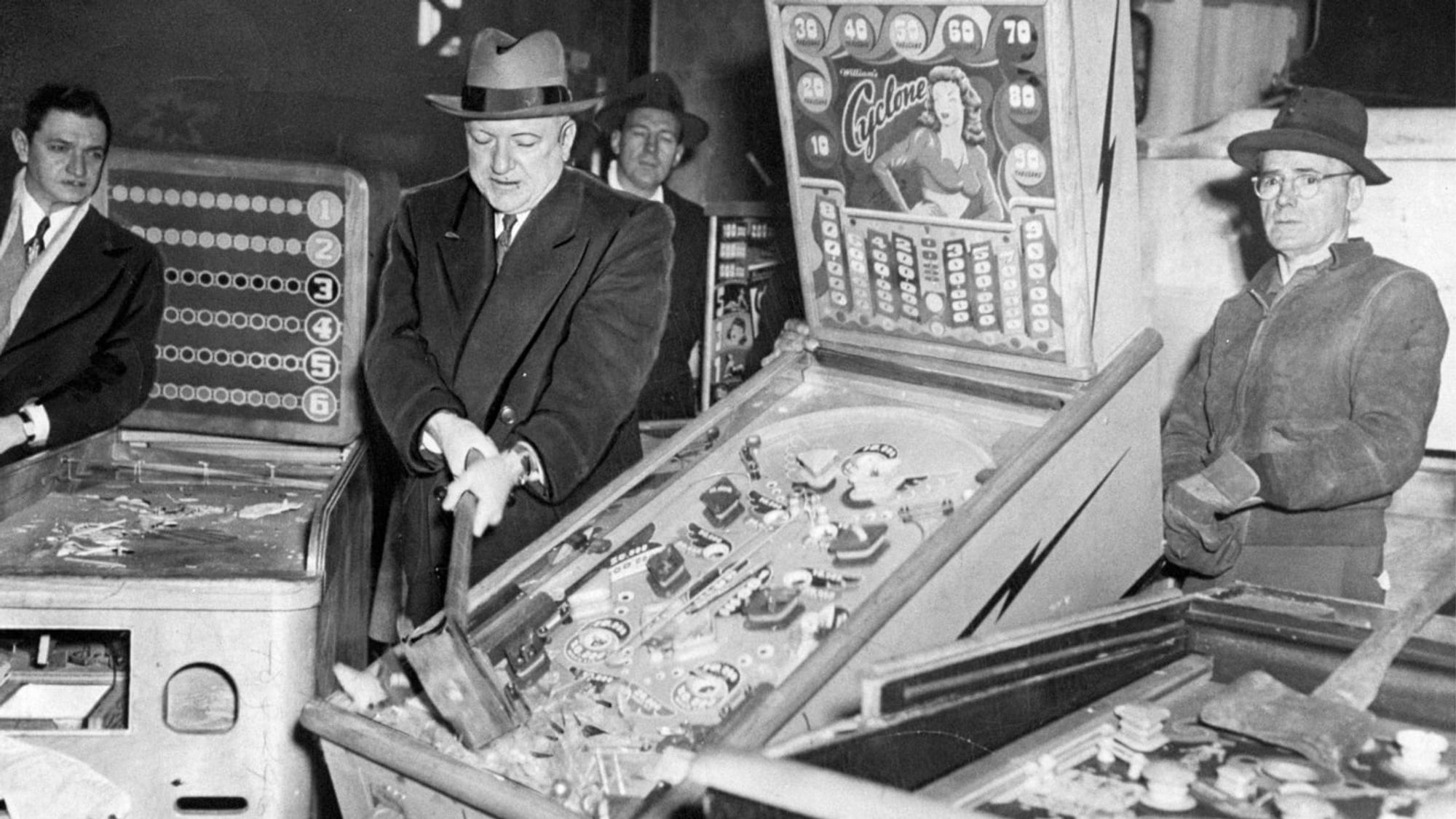 Photograph of Fiorello la Guardia smashing a pinball table with a sledgehammer