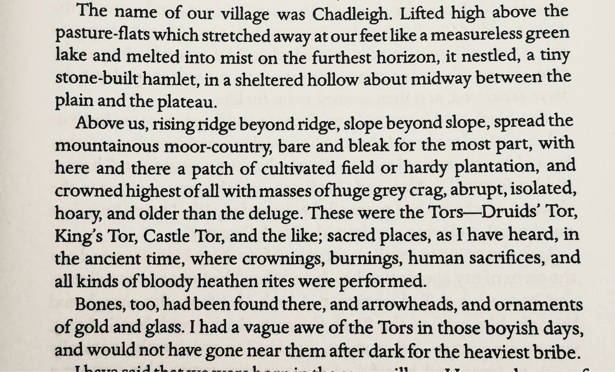 … village was Chadleigh. Lifted high above the pasture-flats which stretched away at our feet like a measureless green lake and melted into mist on the furthest horizon, it nestled, a tiny stone-built hamlet, in a sheltered hollow about midway between the plain and the plateau.
Above us, rising ridge beyond ridge, slope beyond slope, spread the mountainous moor-country, bare and bleak for the most part, with here and there a patch of cultivated field or hardy plantation, and crowned highest of all with masses of huge grey crag, abrupt, isolated, hoary, and older than the deluge. These were the Tors-Druids' Tor, King's Tor, Castle Tor, and the like; sacred places, as I have heard, in the ancient time, where crownings, burnings, human sacrifices, and all kinds of bloody heathen rites were performed.
Bones, too, had been found there, and arrowheads, and ornaments of gold and glass. I had a vague awe of the Tors and would not have gone near them after dark for the heaviest bribe