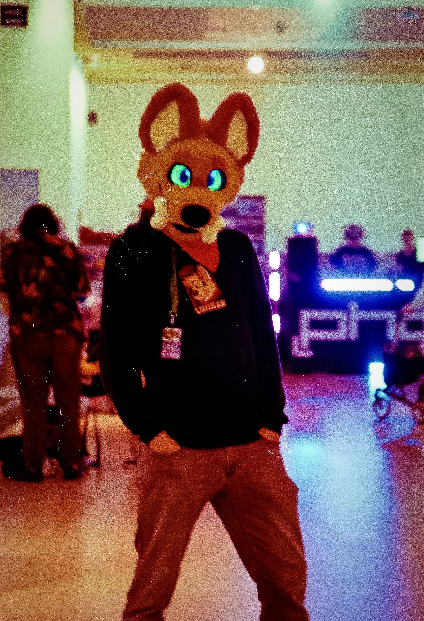 A partial Fursuiter standing in a "club area" inside the CCH during EF