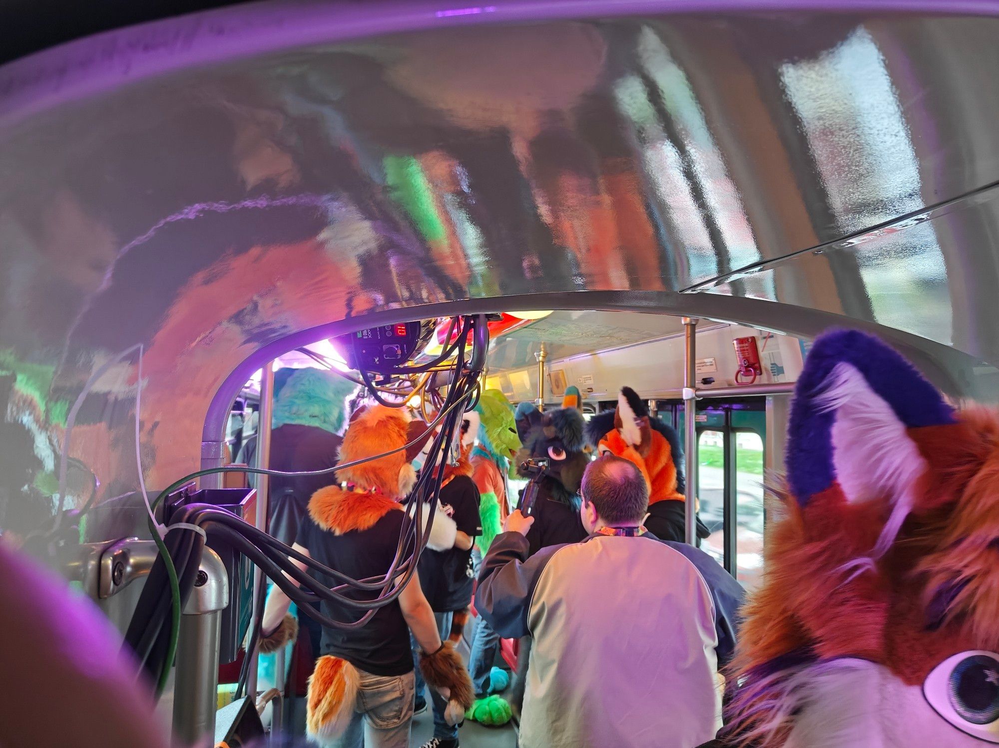 A photo of the inside of the moving tram, Suiters are seen dancing.