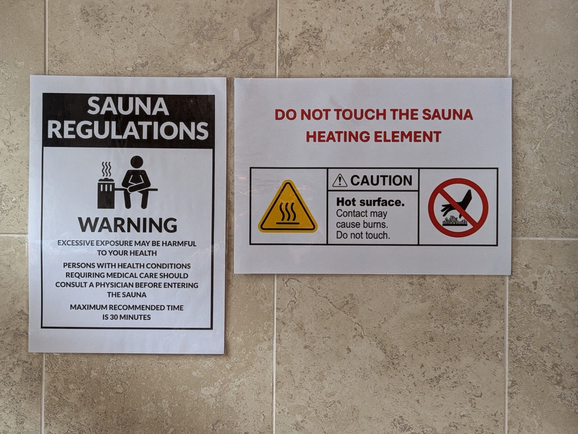 A photo of a bathroom with signs showing sauna regulations that you'd expect to see in a business.