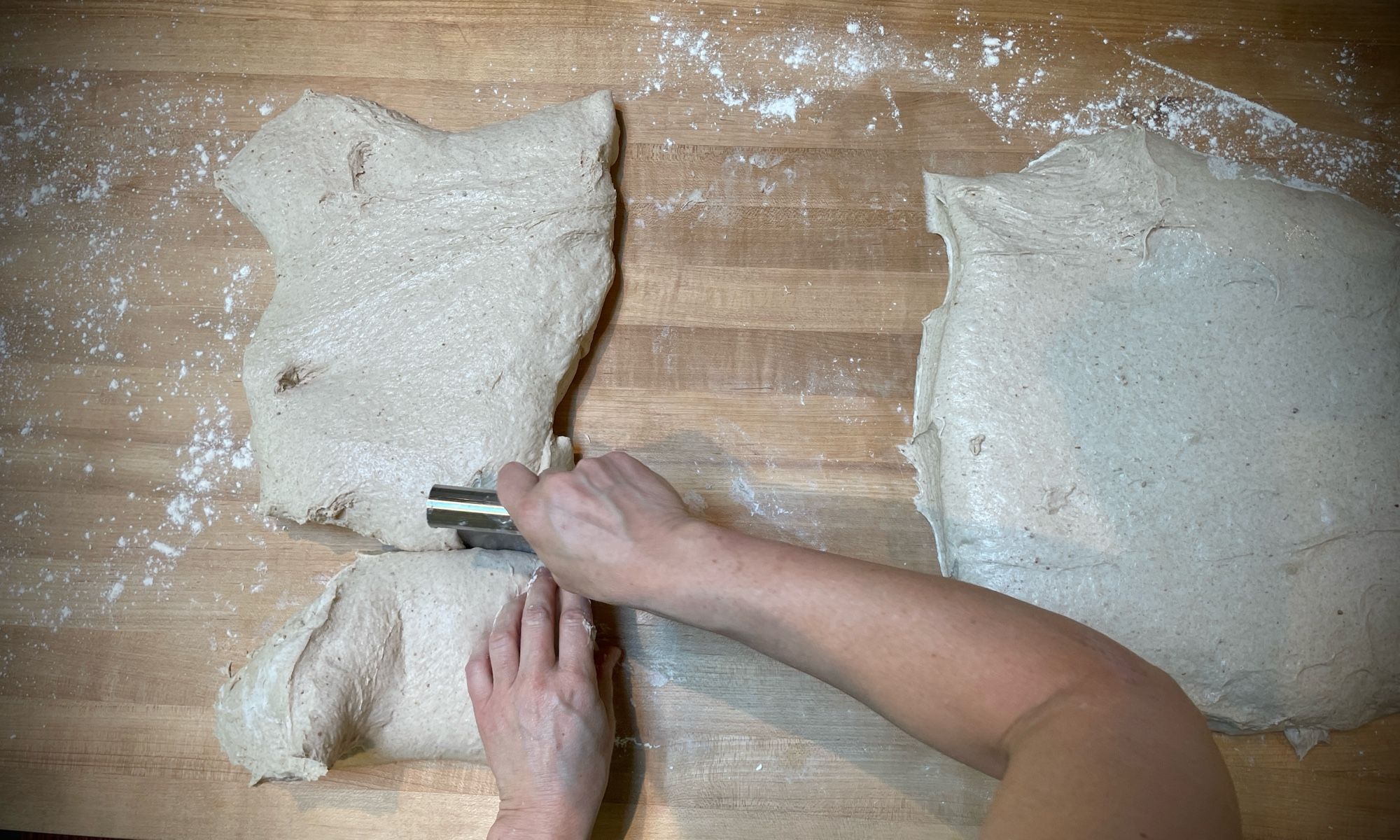 A 7 kilogram pile of dough being portioned to bake sourdough bread tomorrow morning.