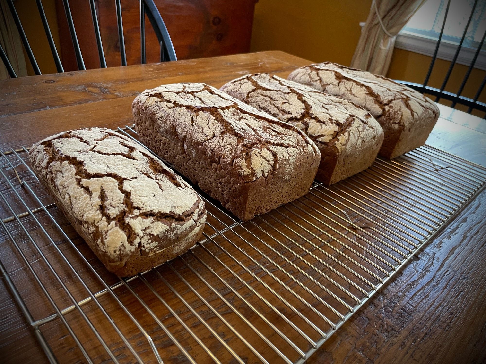 Four loaves of freshly baked rye bread.