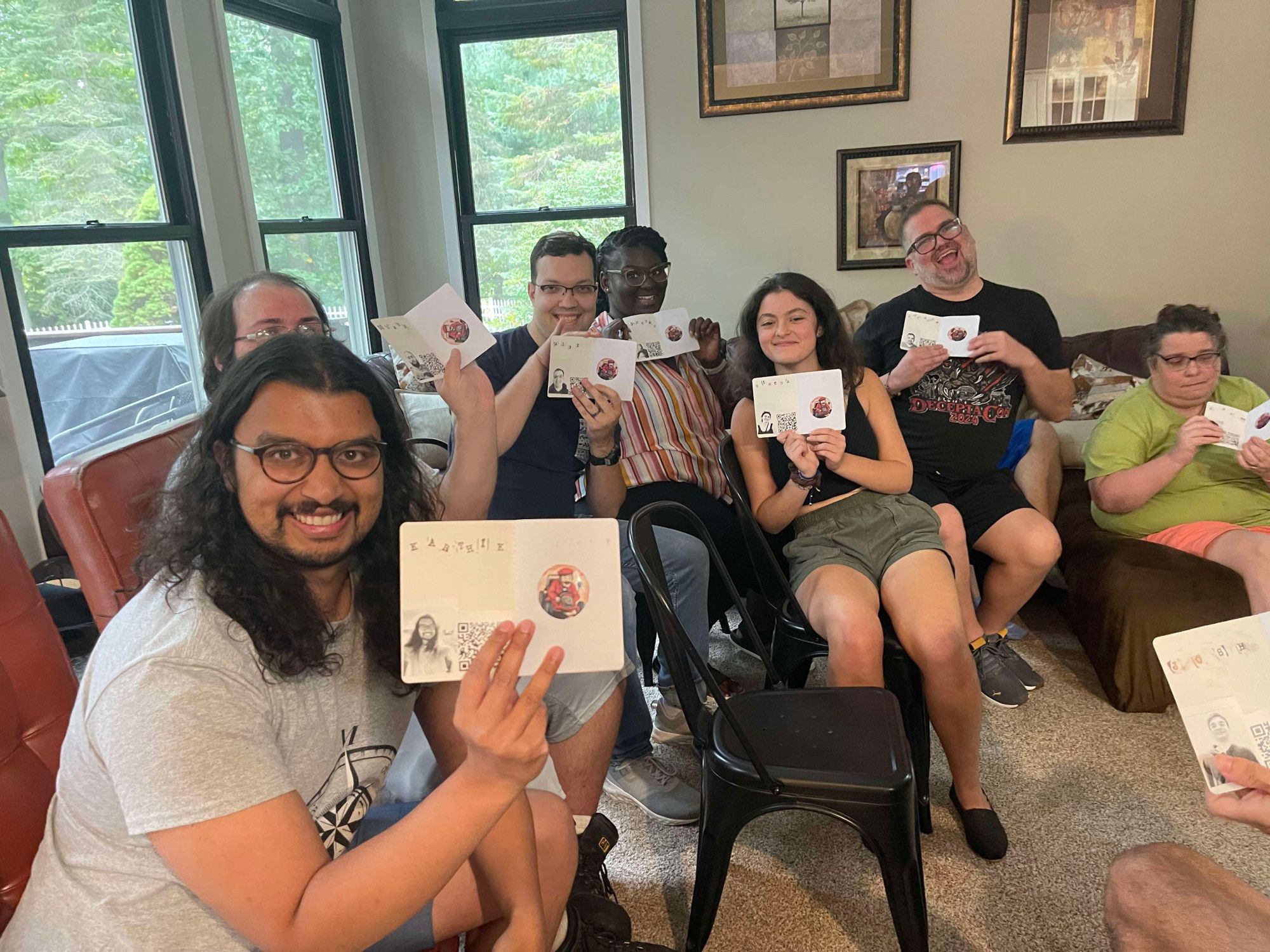 A group of people holding up passports with their first of many stamps for surviving an elimination