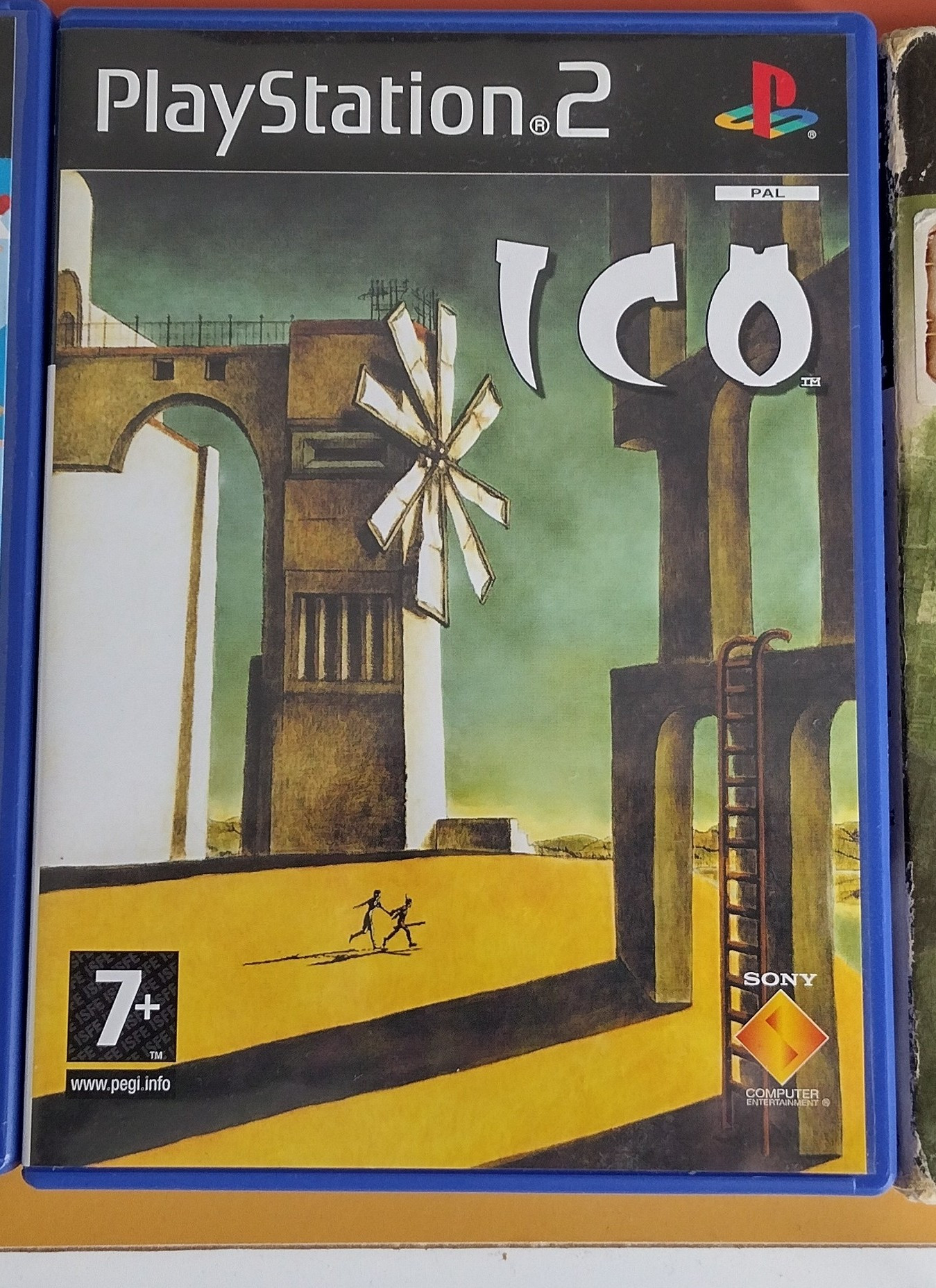 PAL PS2 copy of the game ICO. The key art features the protagonist Ico and Yorda walking across a landscape filled with tall structures.