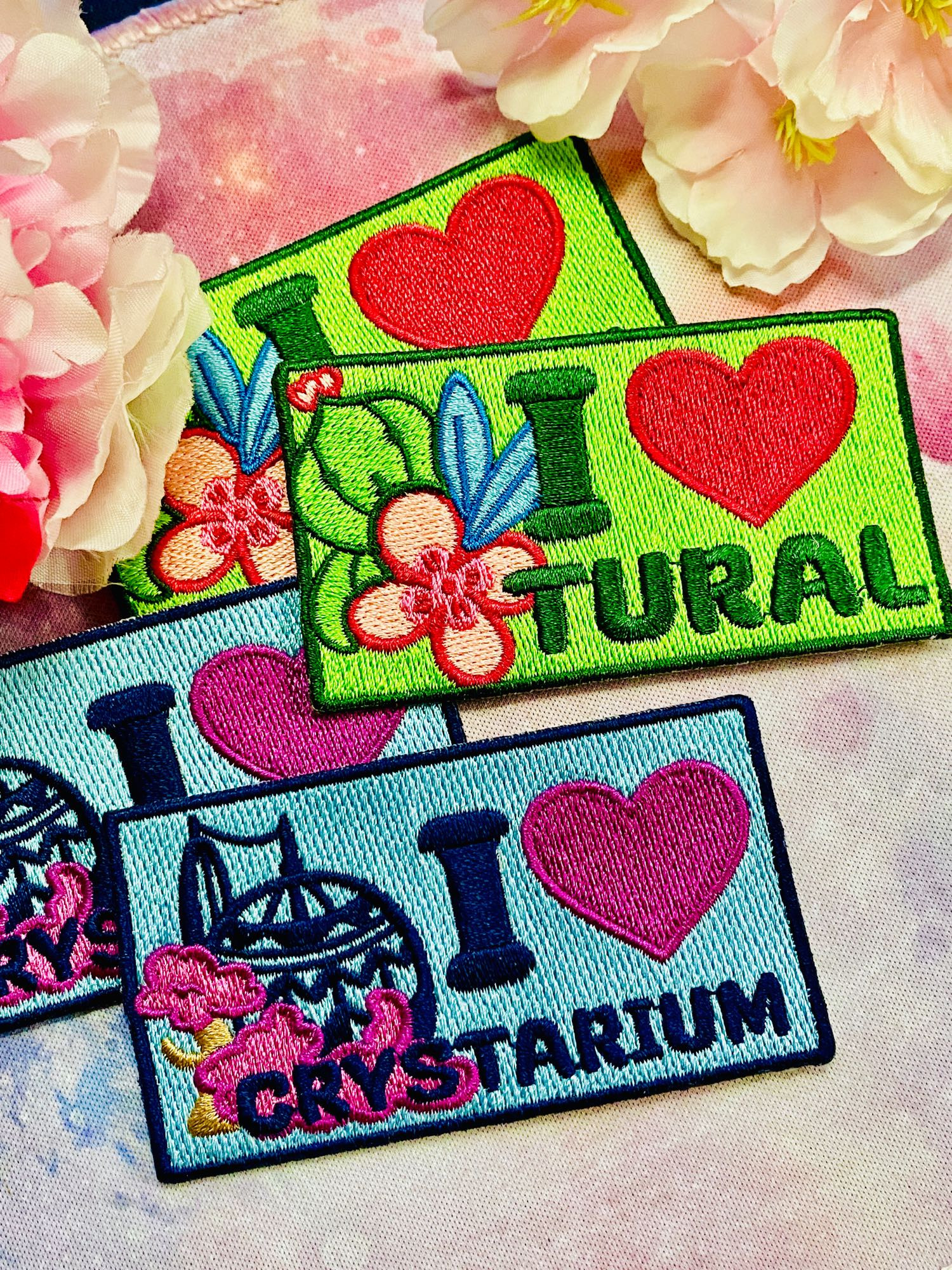 Embroidered patches that say I ❤️ Tural and I ❤️ Crystarium 