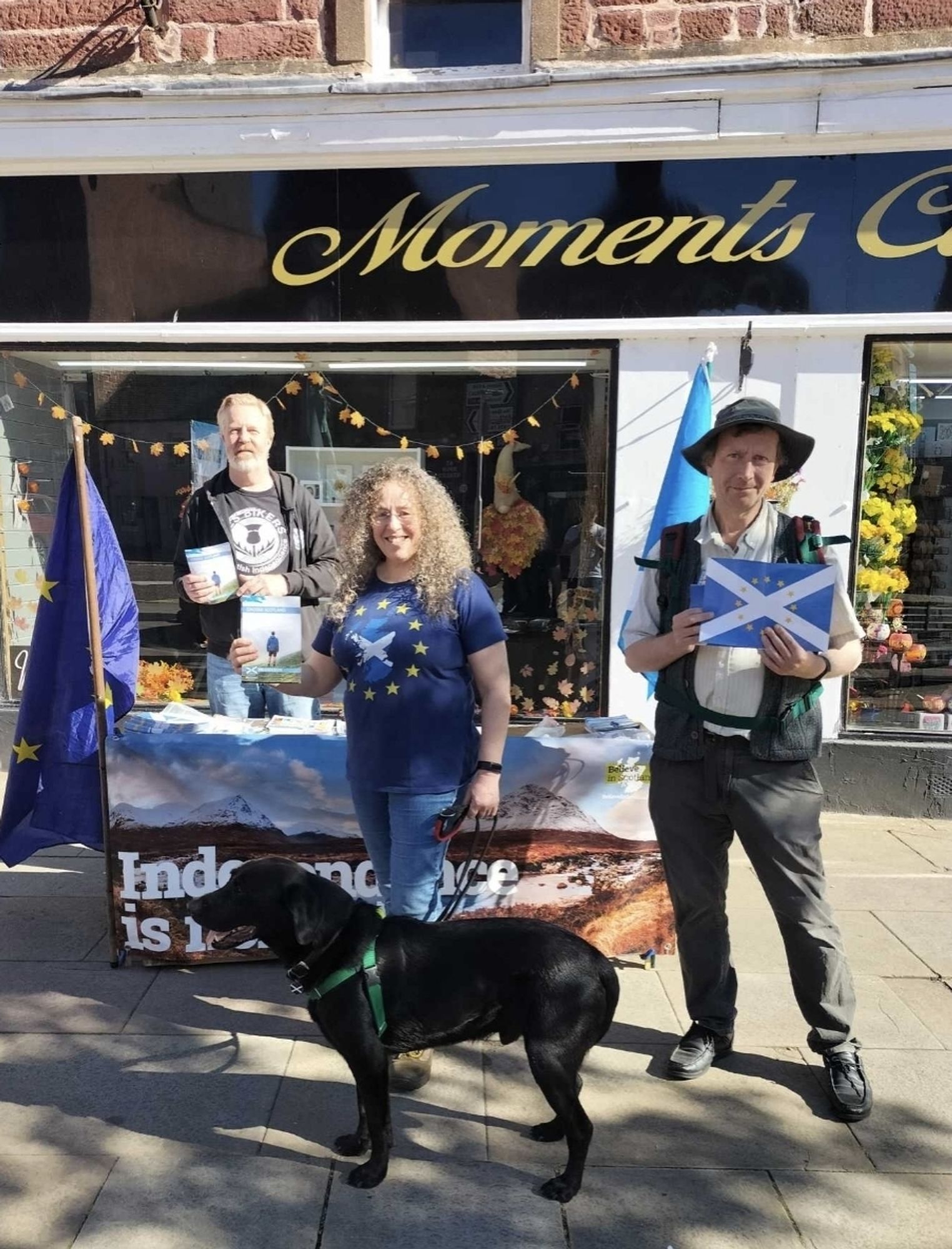 Three smiling people at a Yes stall for Scottish Independence in Europe