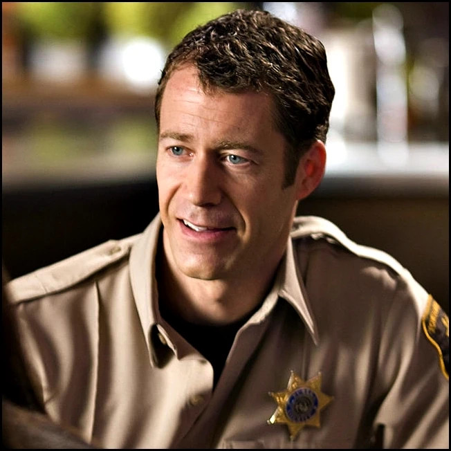 A picture of Sheriff Jack Carter from the scifi TV show Eureka, who is a normal guy in a town full of geniuses and scientists. His IQ is 111, which he thought was very good and none of the townsfolk and friends had the heart to tell him otherwise.