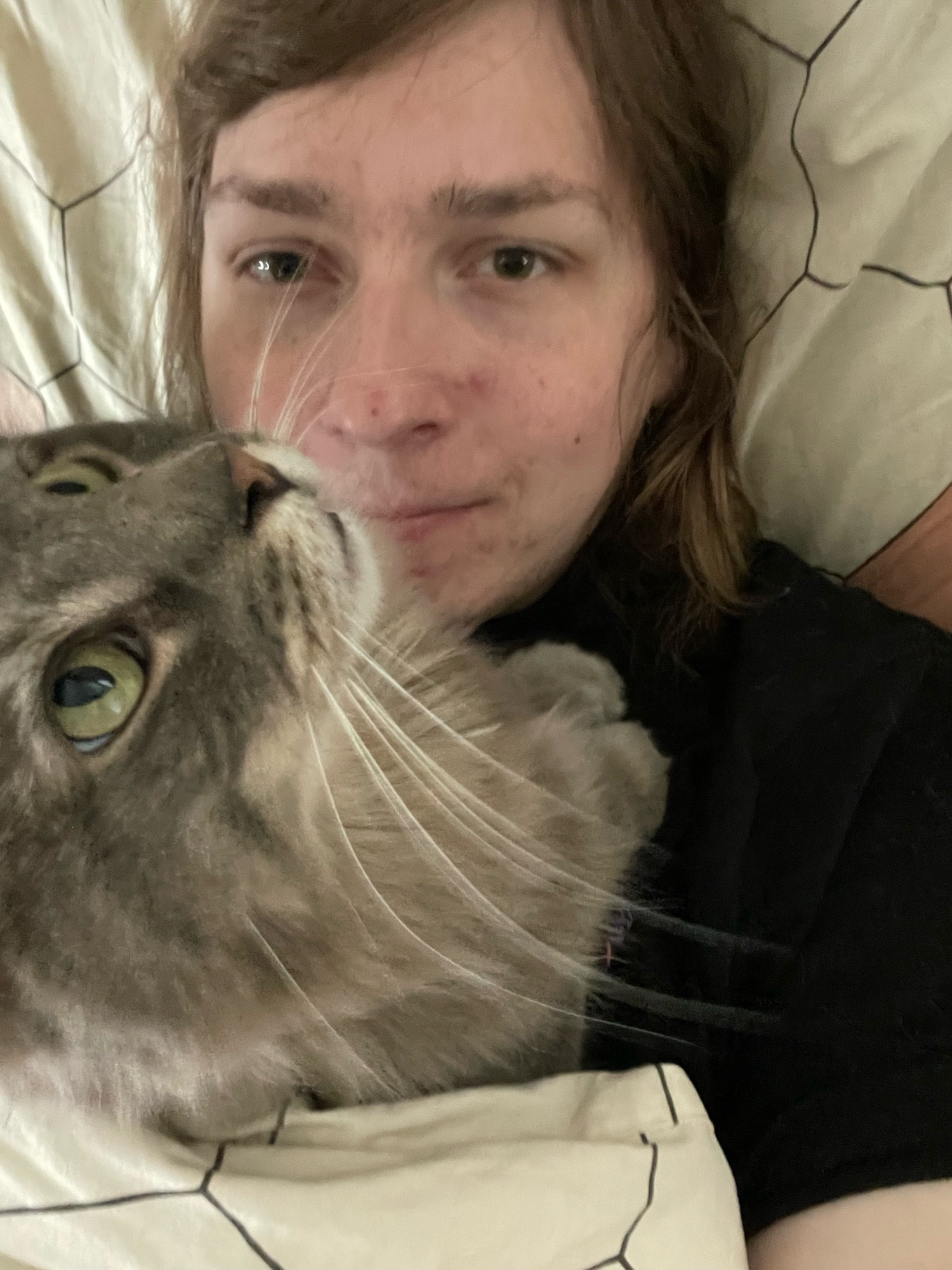 pic of me in bed with my cat laying on top of me