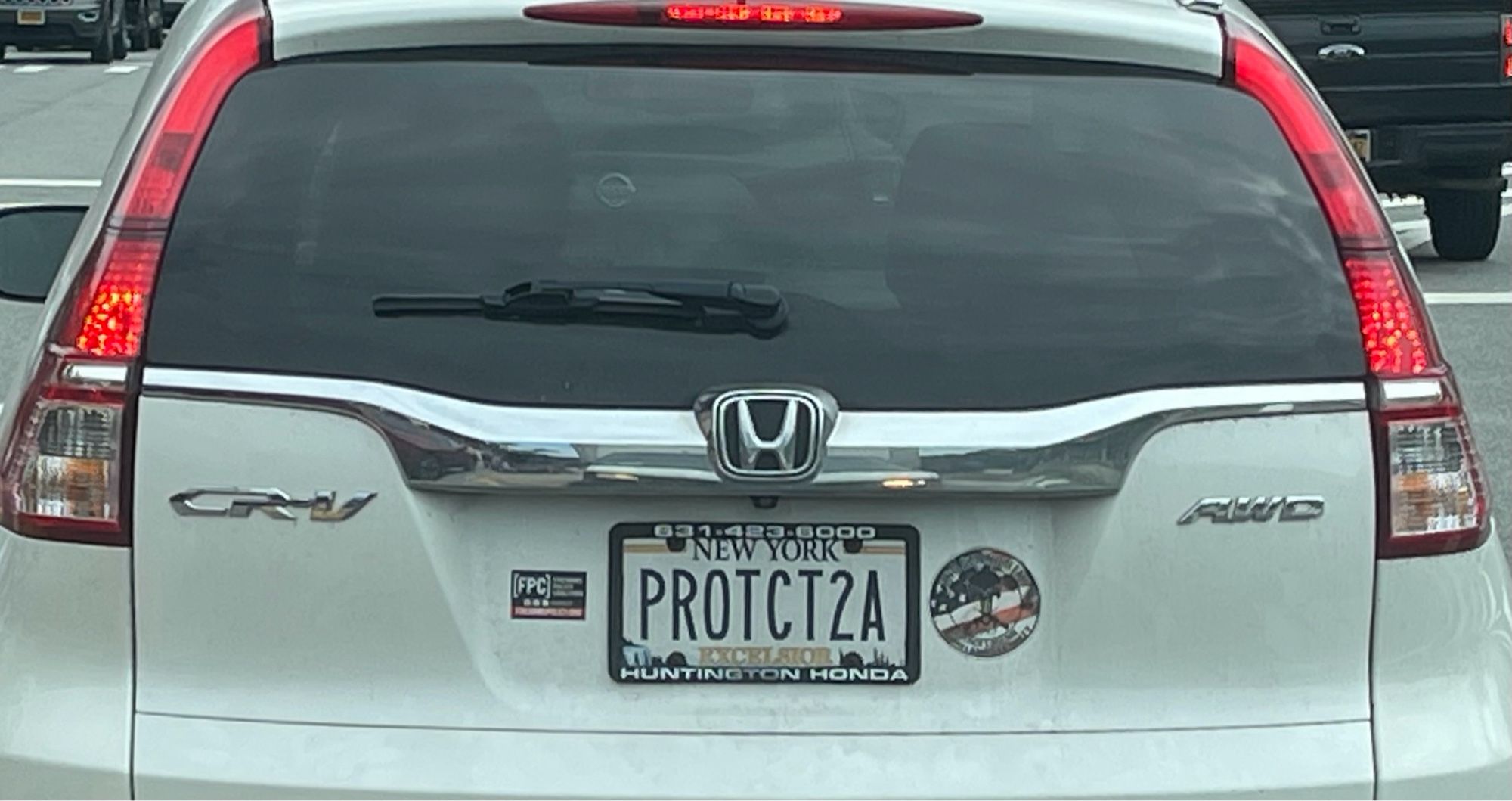 Back of a white Honda CR-V with a vanity plate that reads “PROTCT2A” as shorthand for “protect the 2nd amendment”