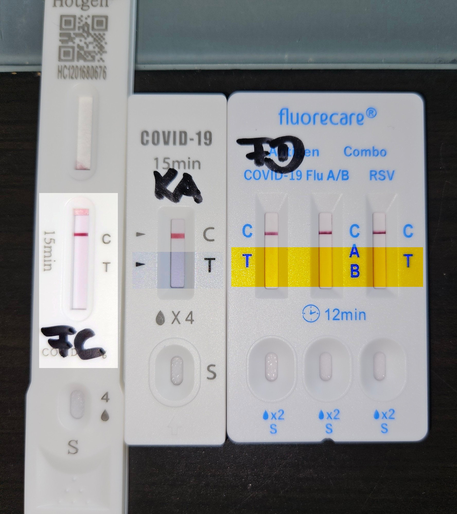 Foto der Schnelltests aus dem Ausgangsposts, nachbearbeitet mit der im Post beschriebenen Methode. Ausgewählt wurde ein größerer Bereich mit Gehäuseanteilen und Beschriftung. Die Teststreifen selbst sind weiterhin weiß bzw. incl Gehäuse plötzlich gelb (bei dem Schnelltest mit blauer statt schwarzer Beschriftung). Der verstärkende Effekt der Tonwertkorrektur fehlt ganz oder fällt marginal aus.