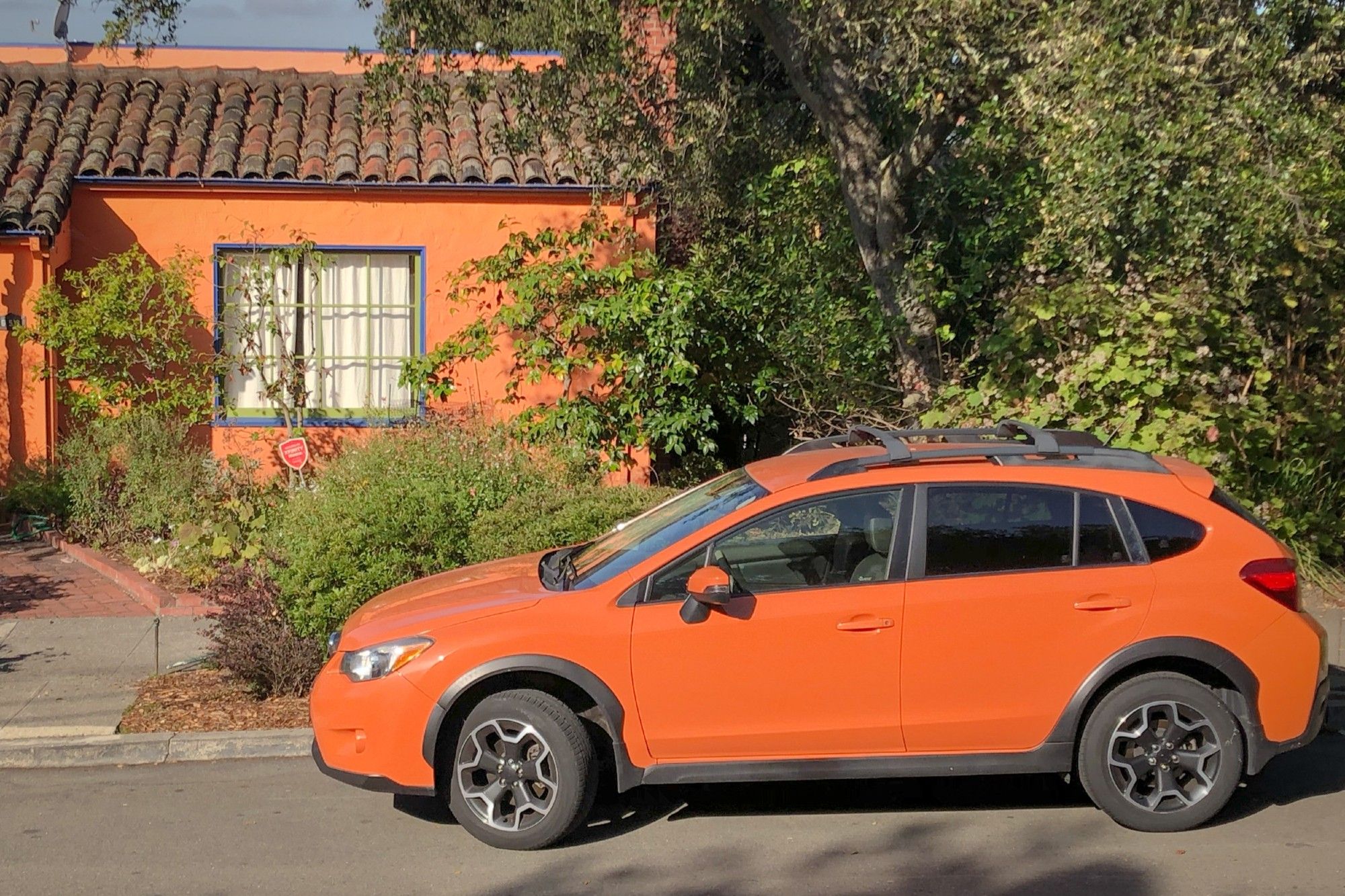 Orange car in front of an orange house