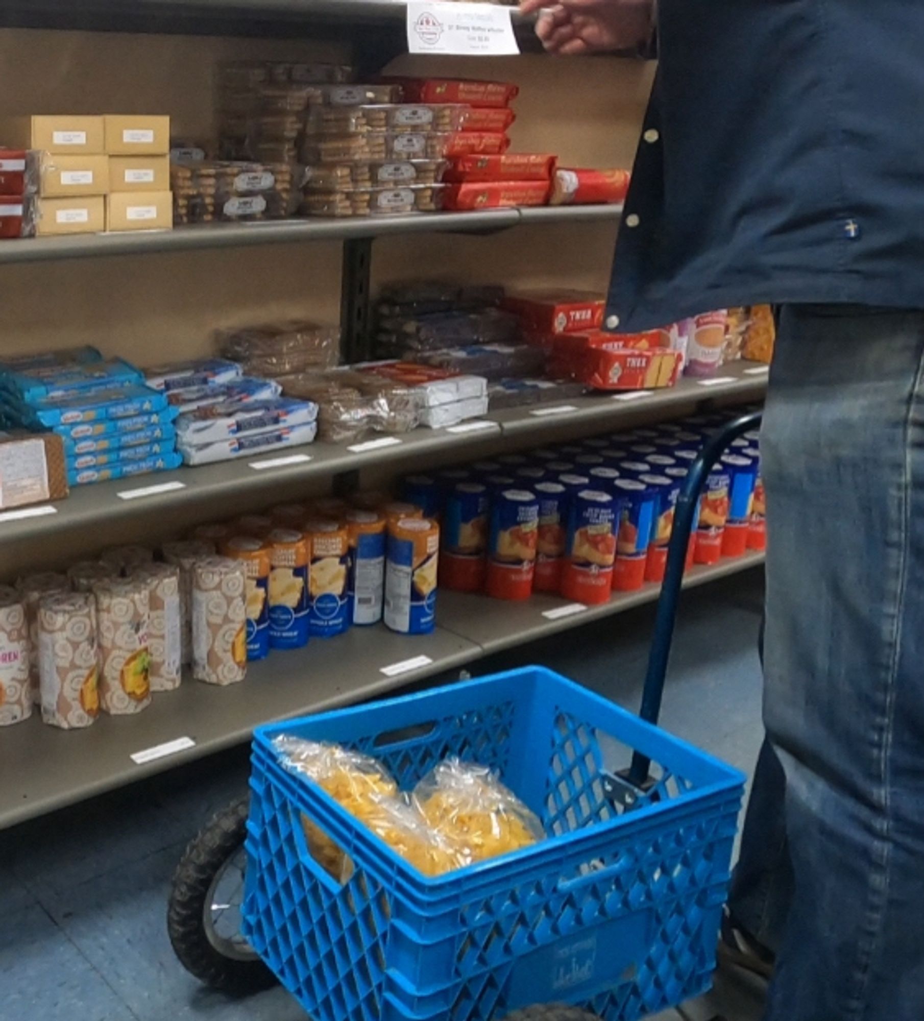 A normaal trailer getting loaded with food at a small shop.