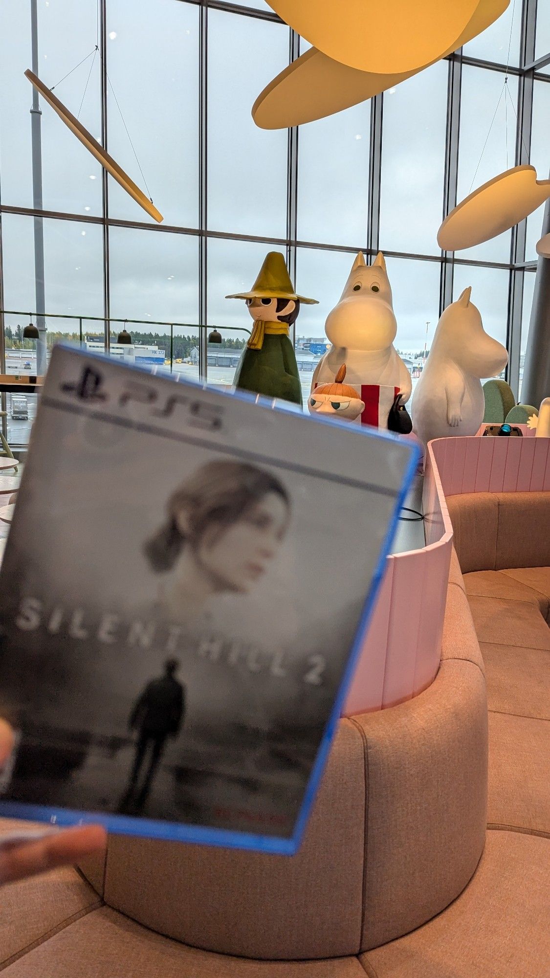 Silent Hill 2 game box in front of airport Moomins