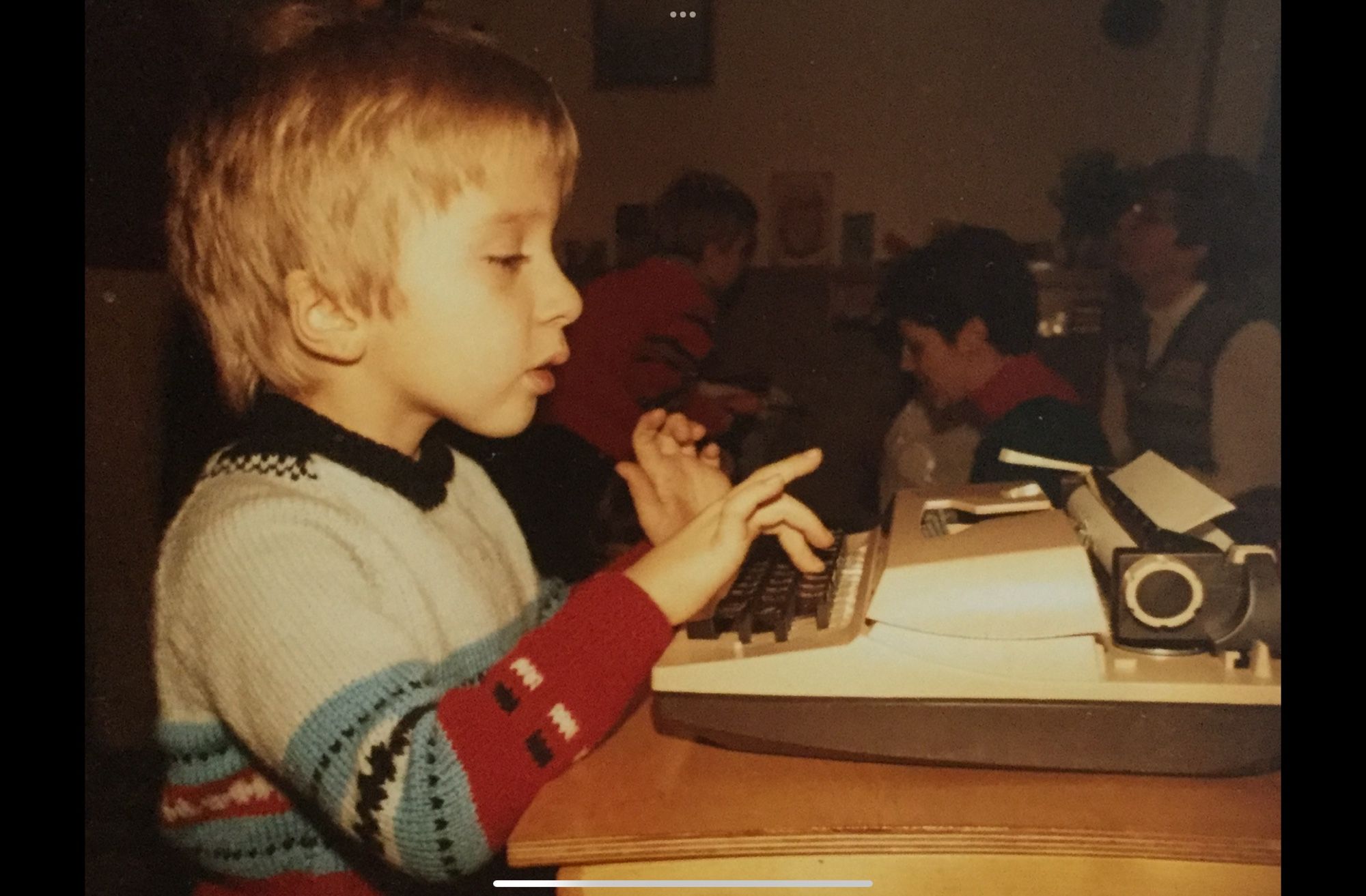 My favourite photo of me. A blond young boy taps away at his brand new typewriter and desk, oblivious to the party going on around him. 