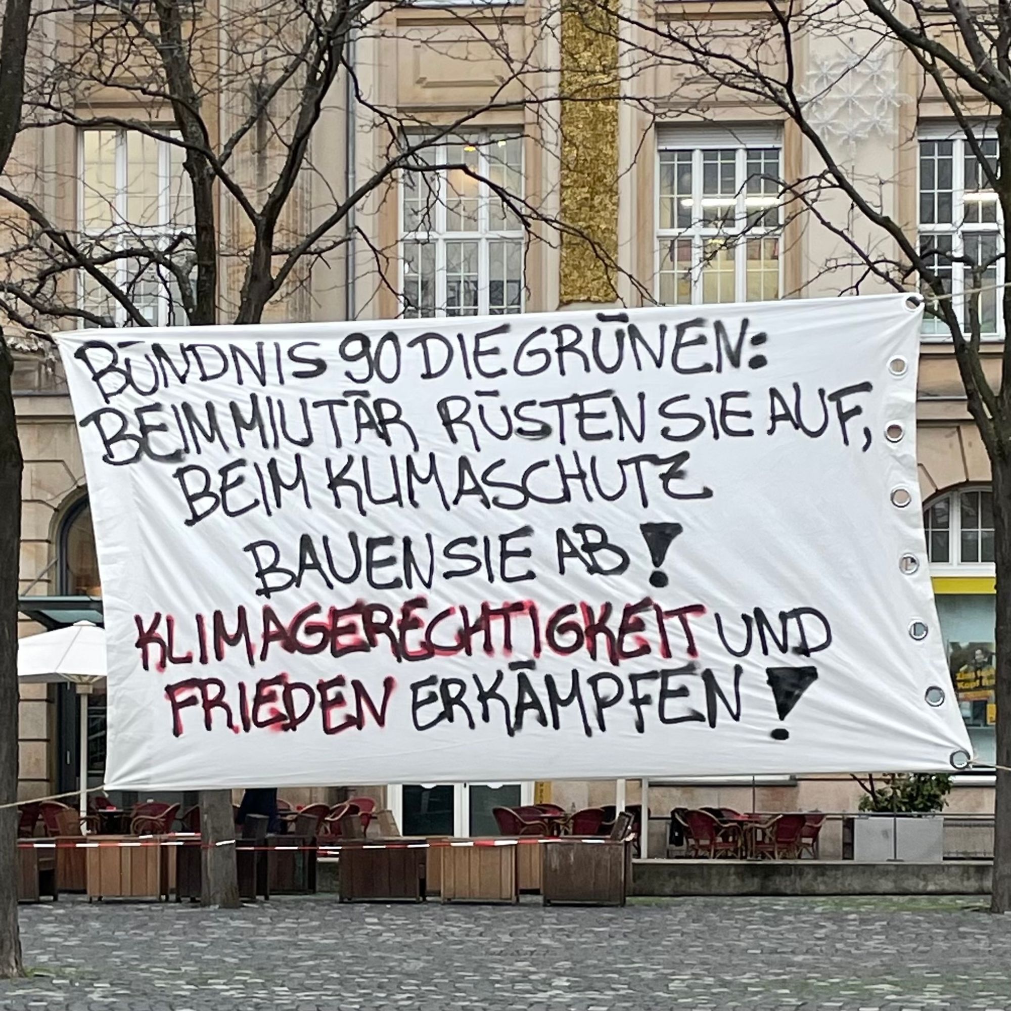 Banner „Bündnis 90 die Grünen: Beim Militär rüsten sie auf, beim Klimaschutz bauen sie ab! Klimagerechtigkeit und Frieden erkämpfen!“