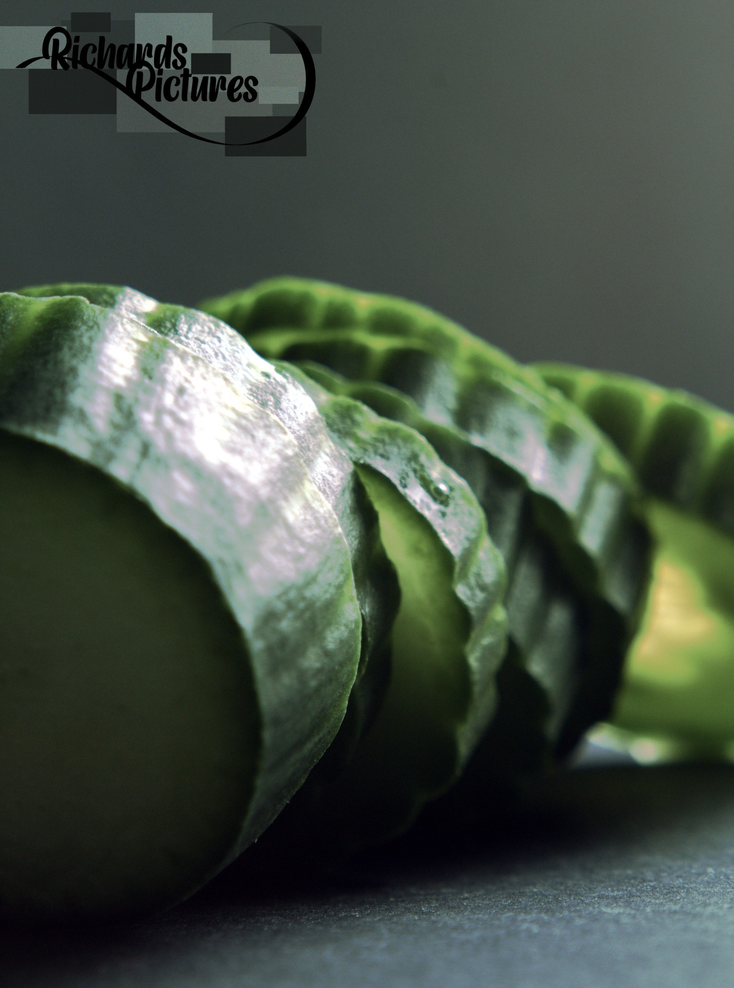 Close-up image of a stack of cucumber.
-Taken around 14:50
-Used a 31mm extension tube. 
-Desaturated the subject and flipped the image.