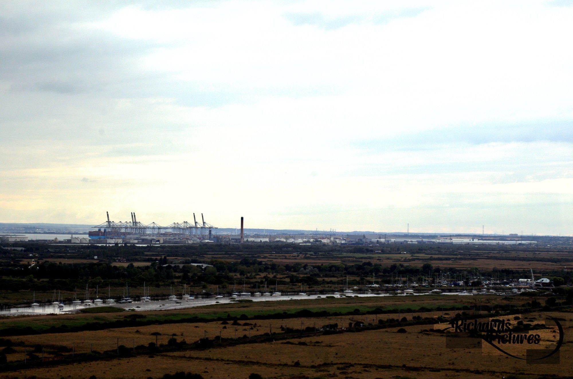 Wide shot of Canvey in the background. Boats in the foreground.