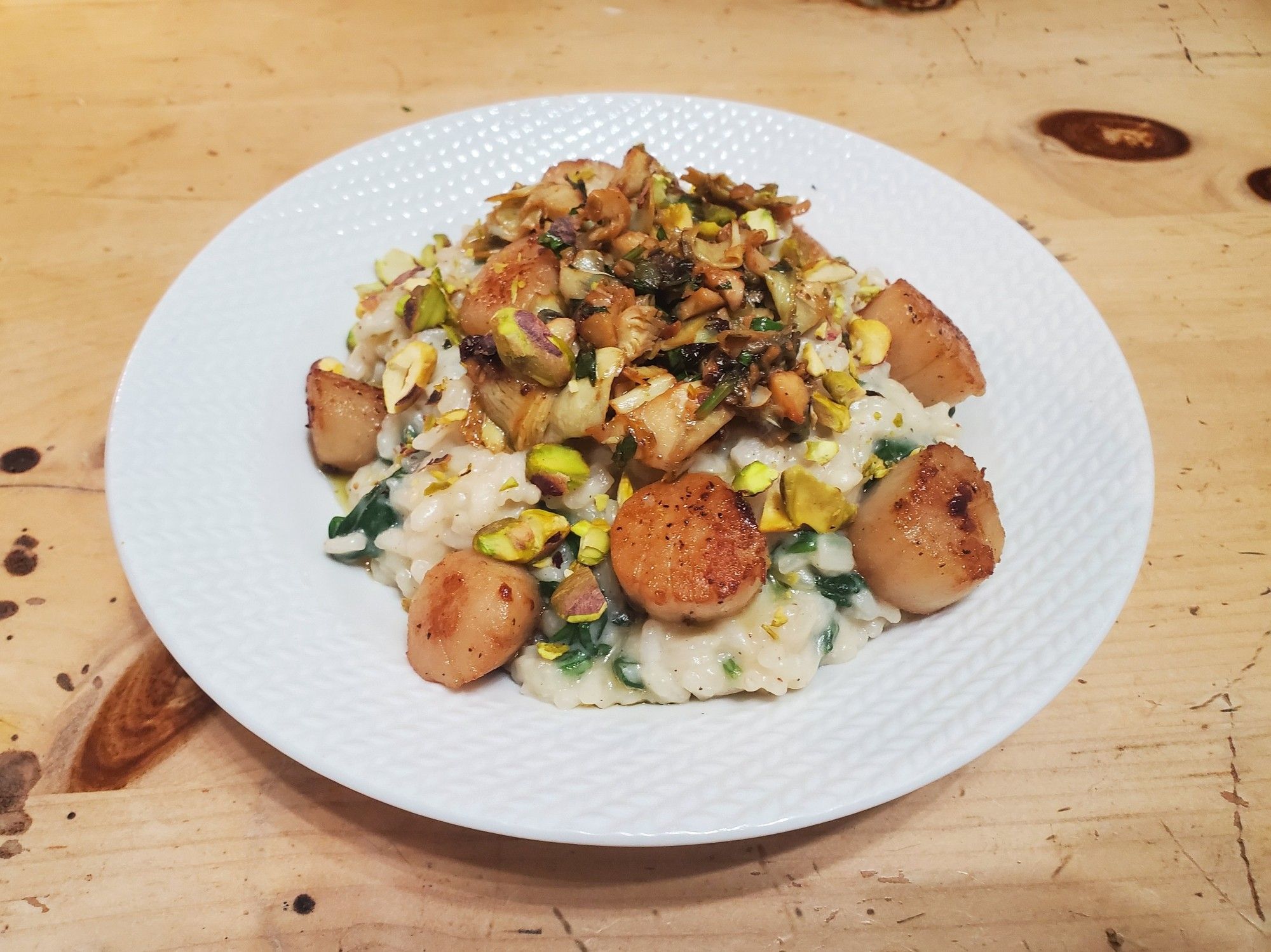 Pistachio, artichoke, and scallop risotto with spinach.