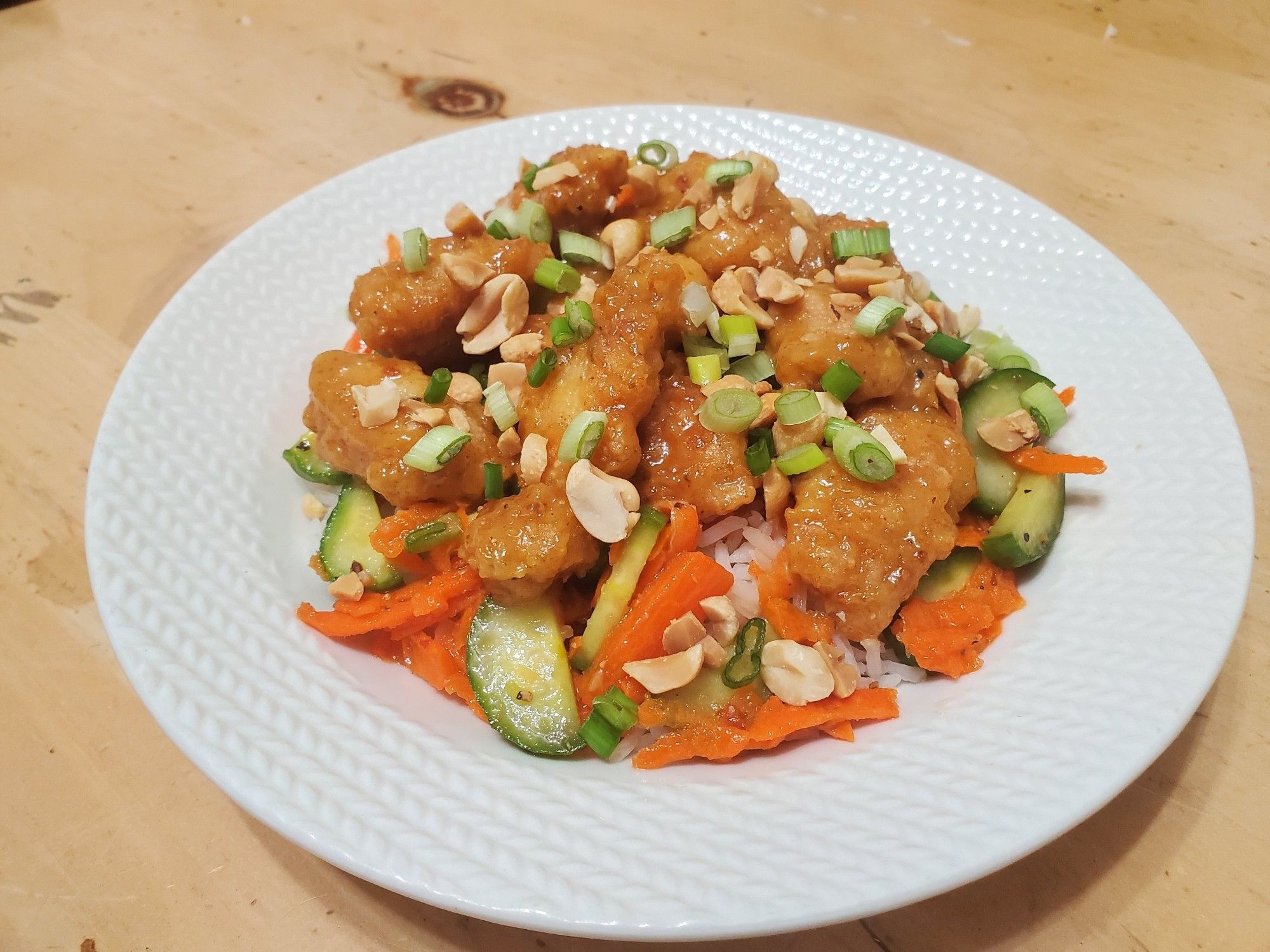 Curry-peanut chicken with marinated vegetables and white rice.