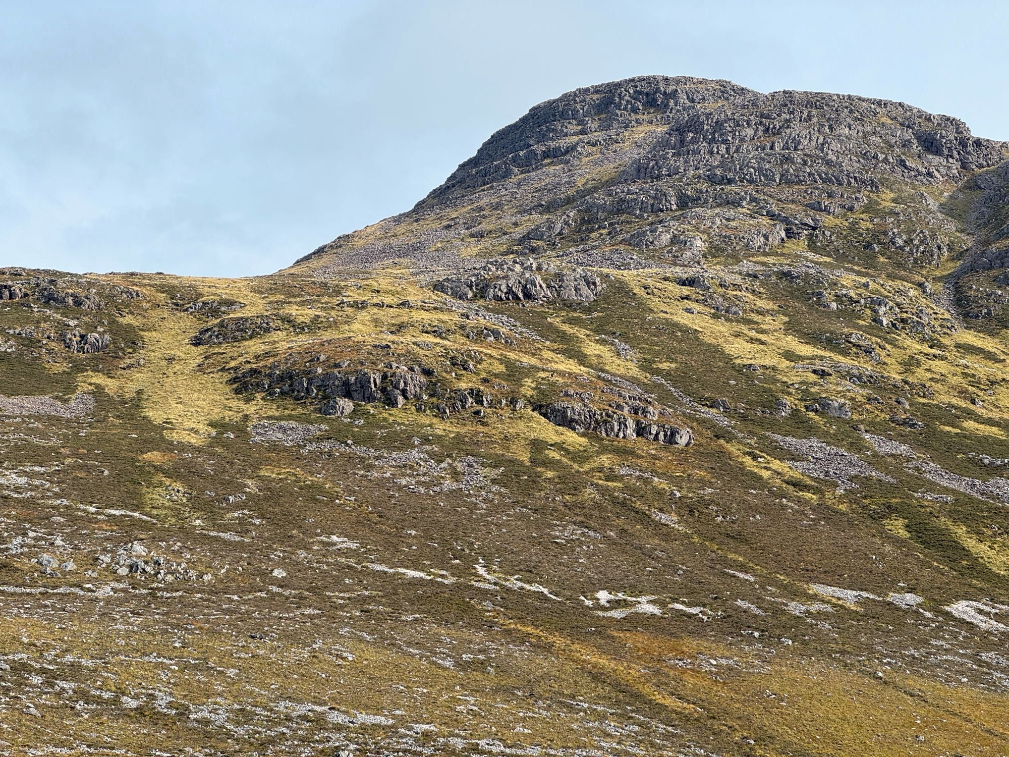 Scottish highlands. A steep sided Munro, Maol Chean-dearg fills the frame with the rocks and scree slope up to the saddle in the top right of the photo.