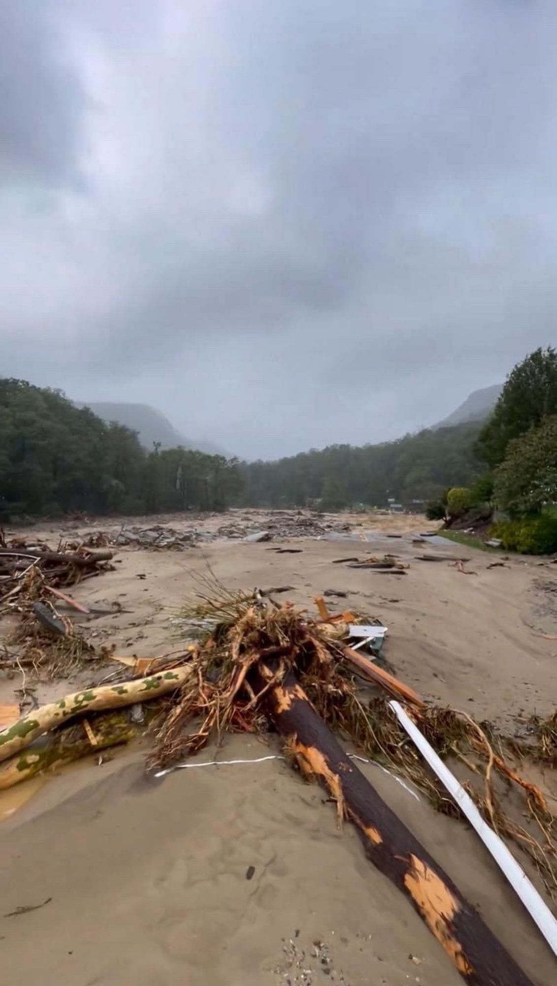 Post storm view of NC-9 in downtown Chimney Rock. All structures are gone after Hurricane Helene flooding, everything is covered in mud & debris.