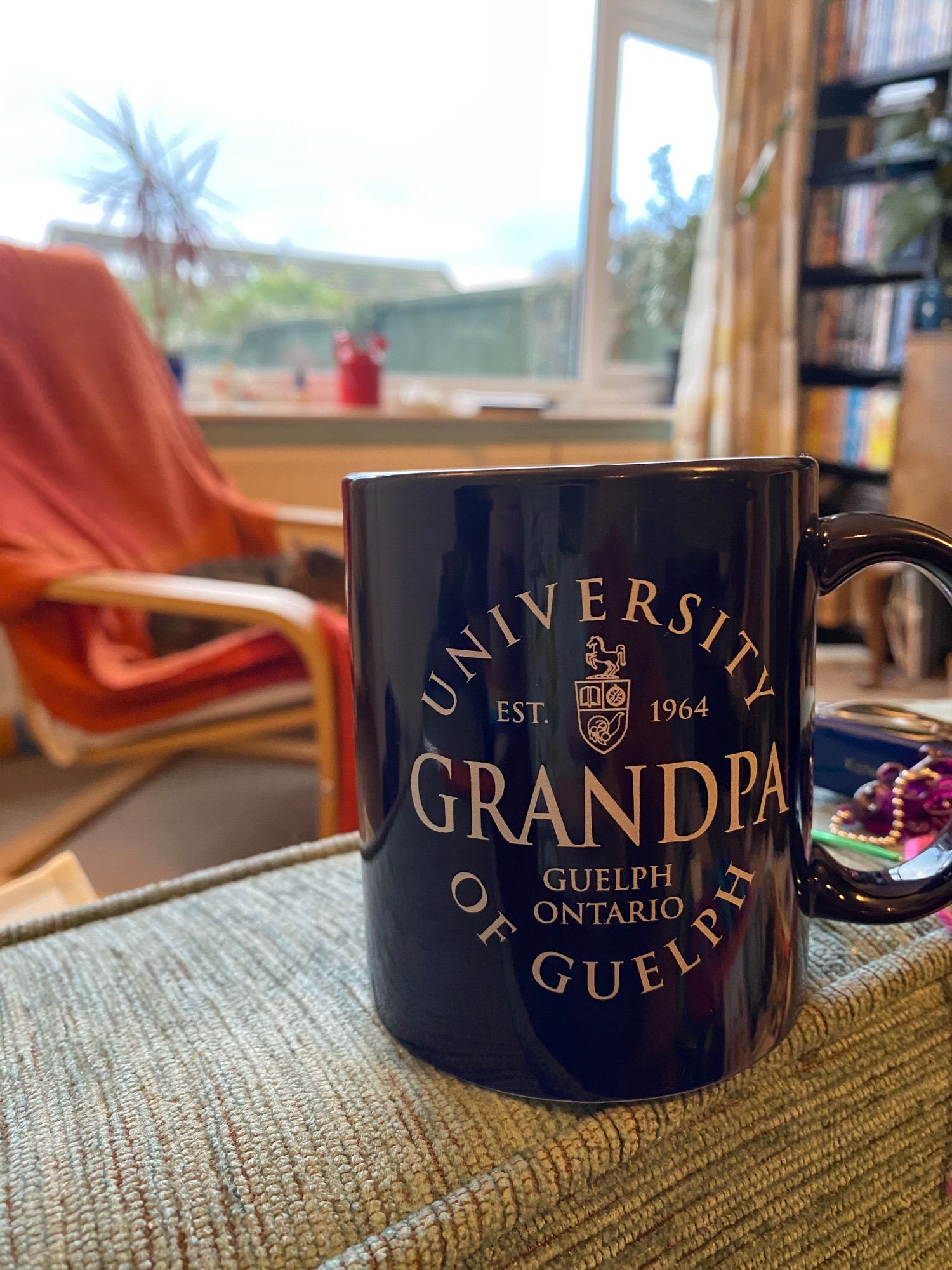 A navy blue mug emblazoned with “University of Guelph Grandpa”.