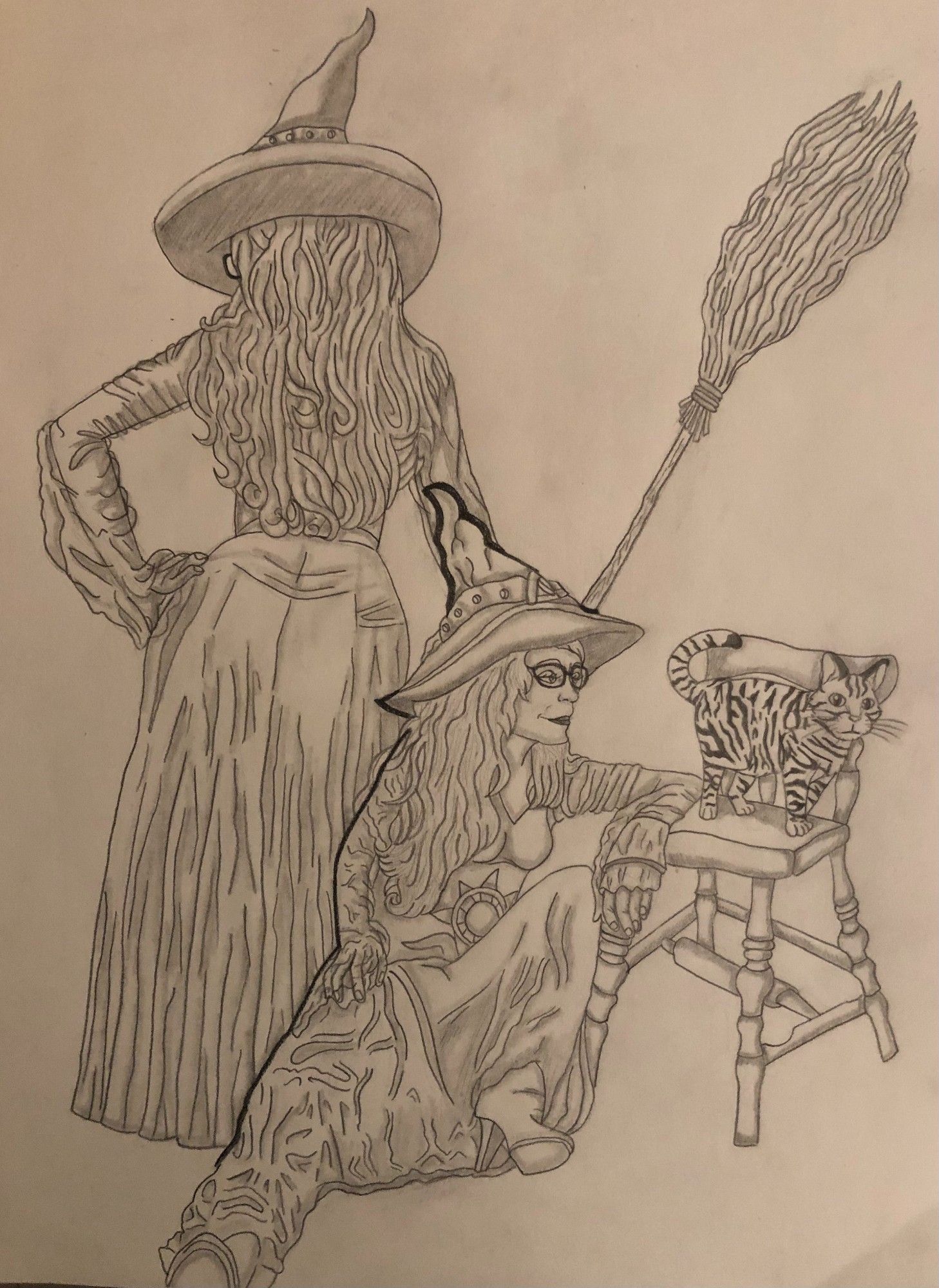 Life drawing exercise of a female model dressed up in a witch's outfit. The front pose is her laying on the floor to tenderly look at a tabby cat on the chair to her right and the second pose has her back turned with her right hand on her hip and her left hand holding up a large broom.