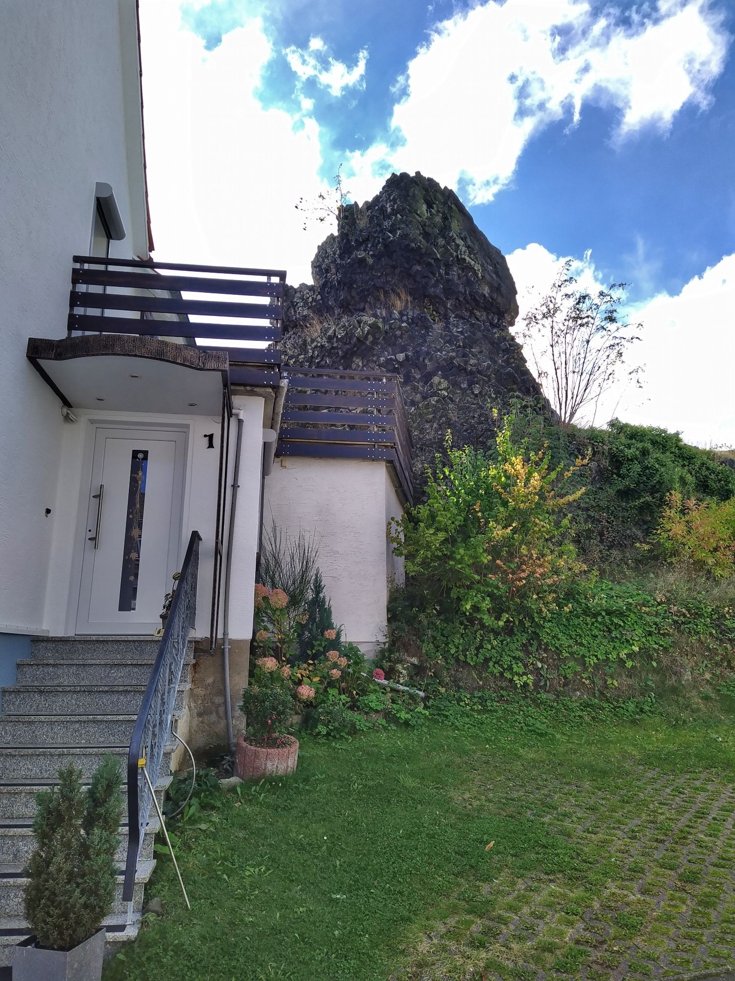 Direkt an Felswand gebaute Terrasse eines Hauses