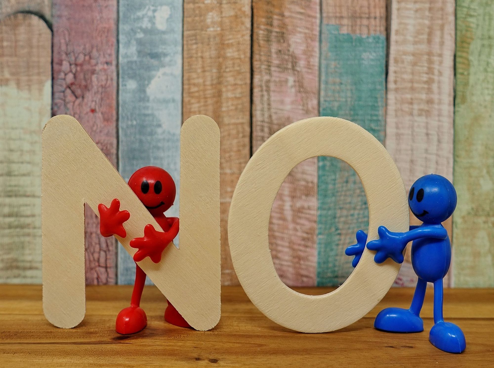 The letters N and O held up by two plastic figures (one red, one blue)