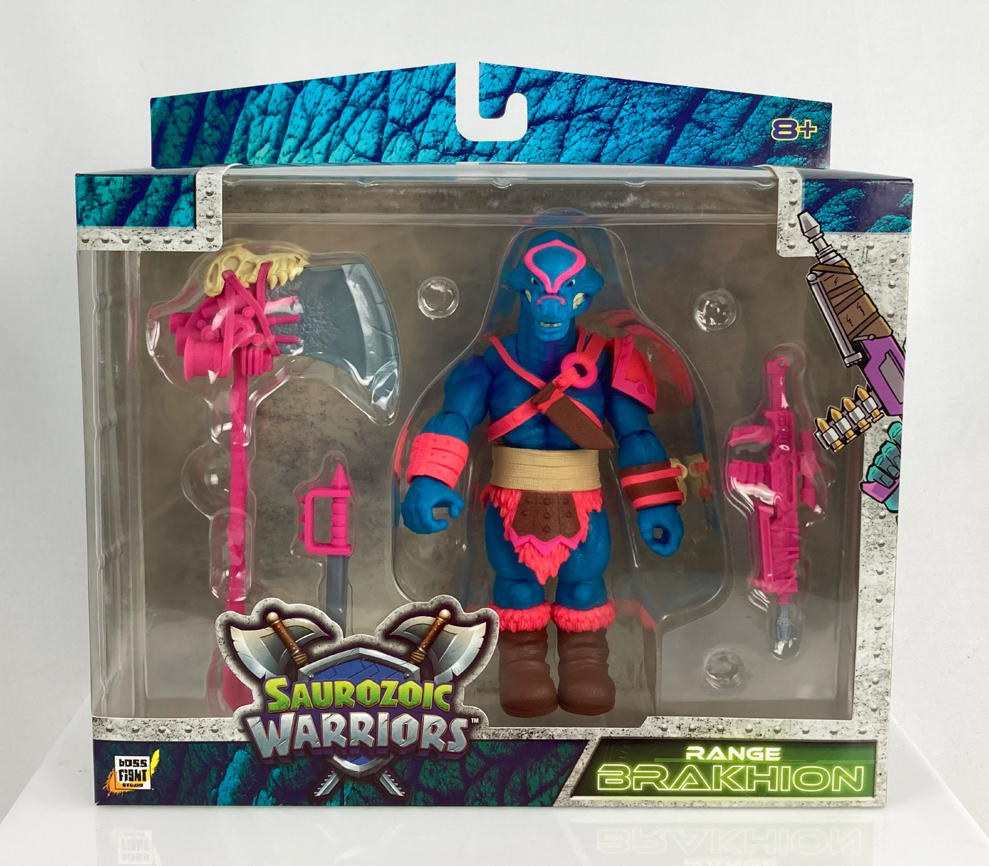 A photo of the Saurozoic Warriors Range Brakhion toy in box - a bright blue and pink Brachiosaurus guy.