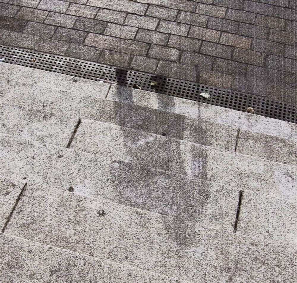 A photograph of a shadow of a person living in Hiroshima on August 6, 1945, who was vaporized as they climbed the steps of the Sumitomo Bank building while using a cane, leaving behind only their shadow imprinted on the steps (because their body and cane momentarily blocked the light from the intense thermal flash, burning away everything on the steps that was not in shadow).