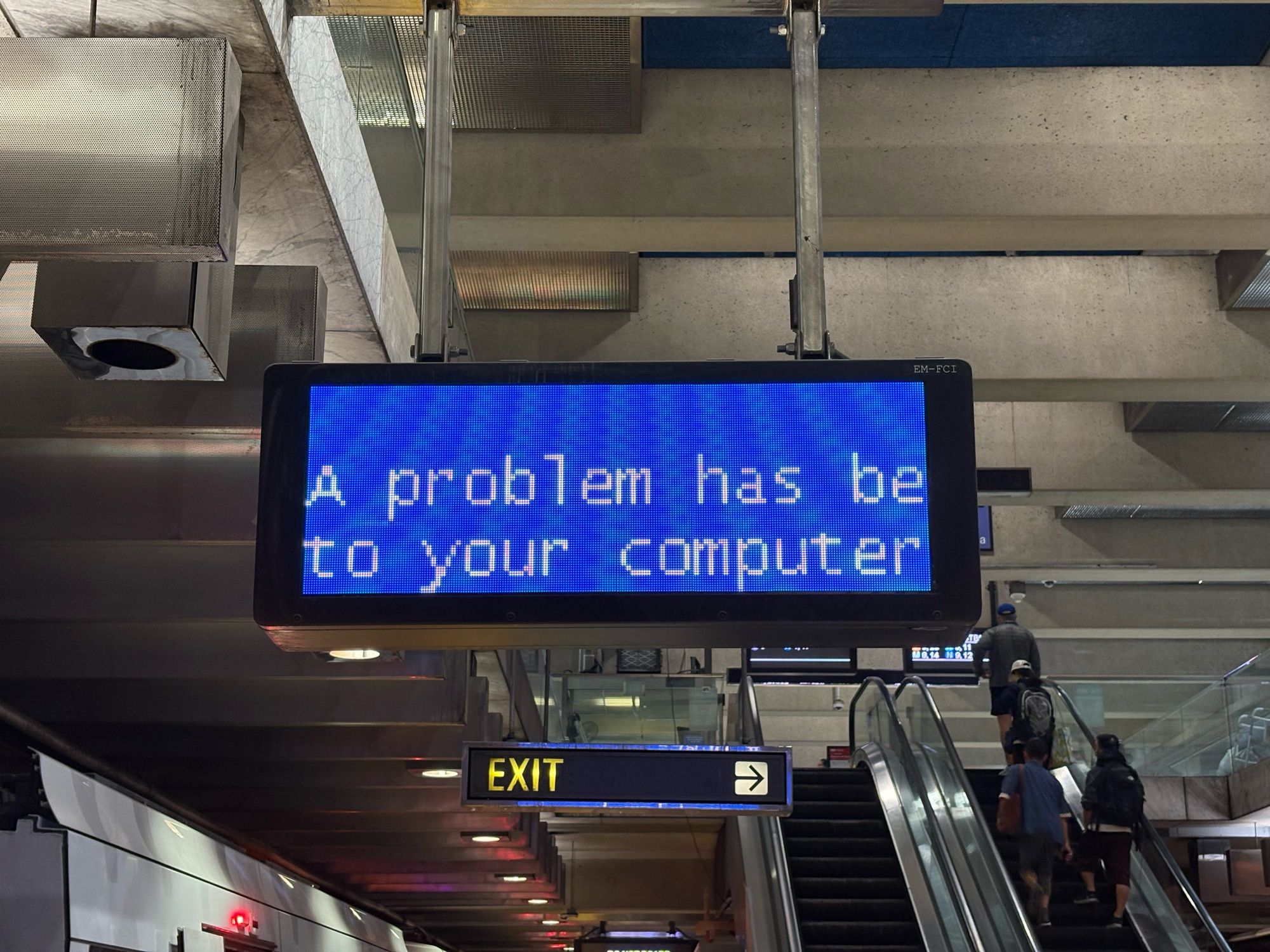 A BSOD (Blue Screen of Death) at SF Muni’s Embarcadero Station. It is zoomed in, only saying “A problem has be to your computer”