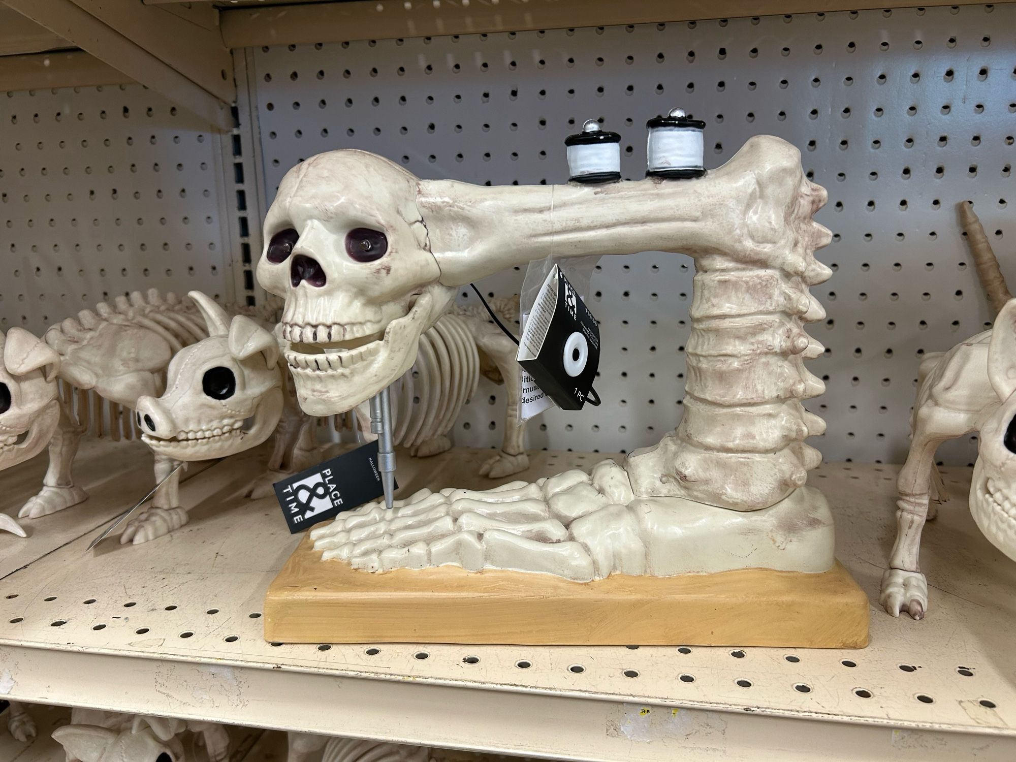 OK, so you those skeleton Halloween decorations where they’ve taken serious artistic liberties with what counts as a “skeleton”? They did that but with a sewing machine. I don’t get it either.