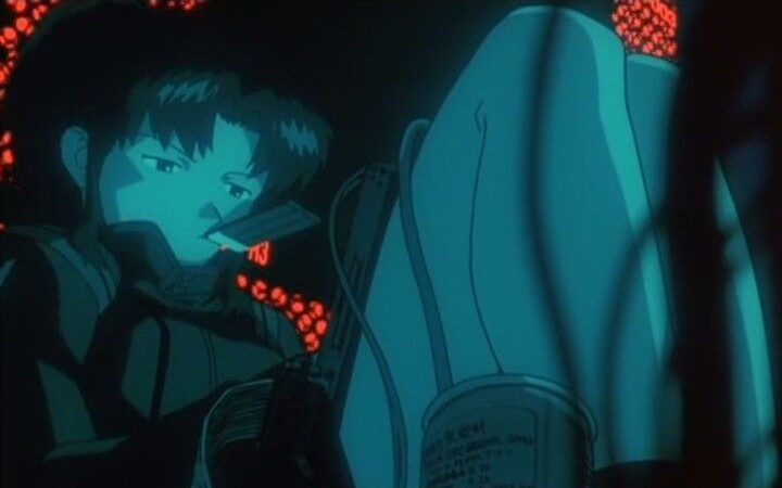 misato holding a data card in her mouth while curled up inside of machinery typing on a tablet with wires around her