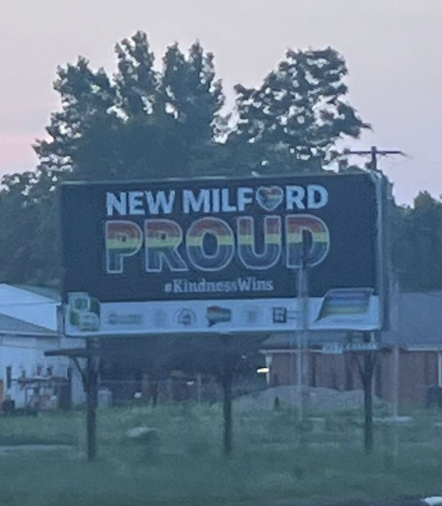 A billboard that says

NEW MILF♥️RD
PROUD
#kindnesswins 