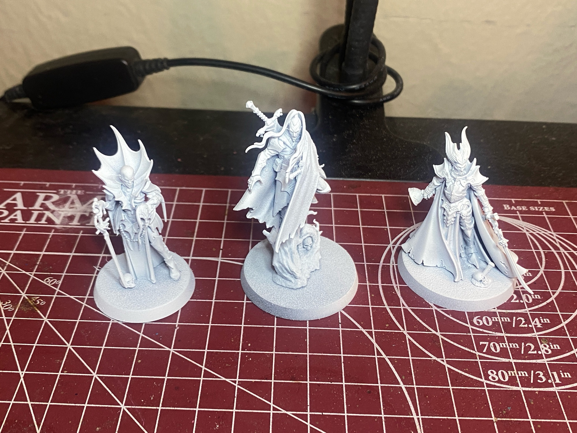 three vampire minis from games workshop's warhammer age of sigmar. currently primed white.

left to right, the minis are: anasta malkarion, cado ezechiar, karlina von carstein