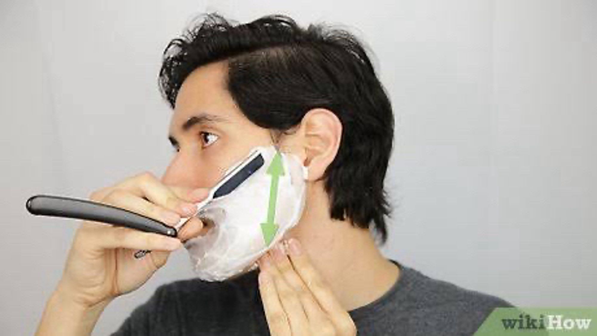 wikihow image of a guy shaving with a straightrazor