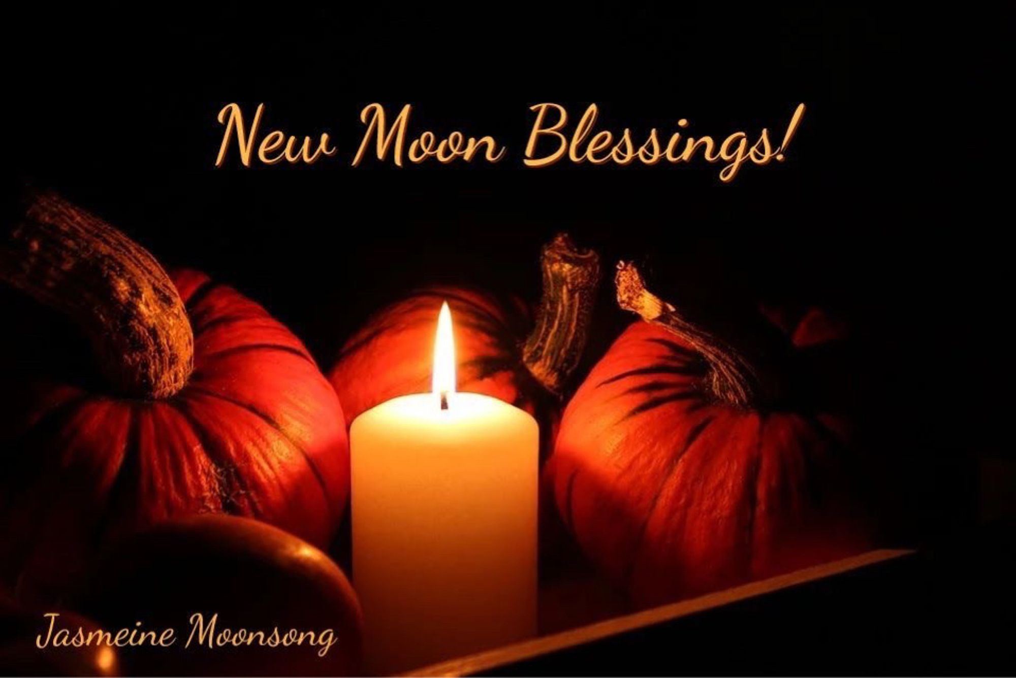 A lit candle sitting amongst pumpkins. New Moon Blessings