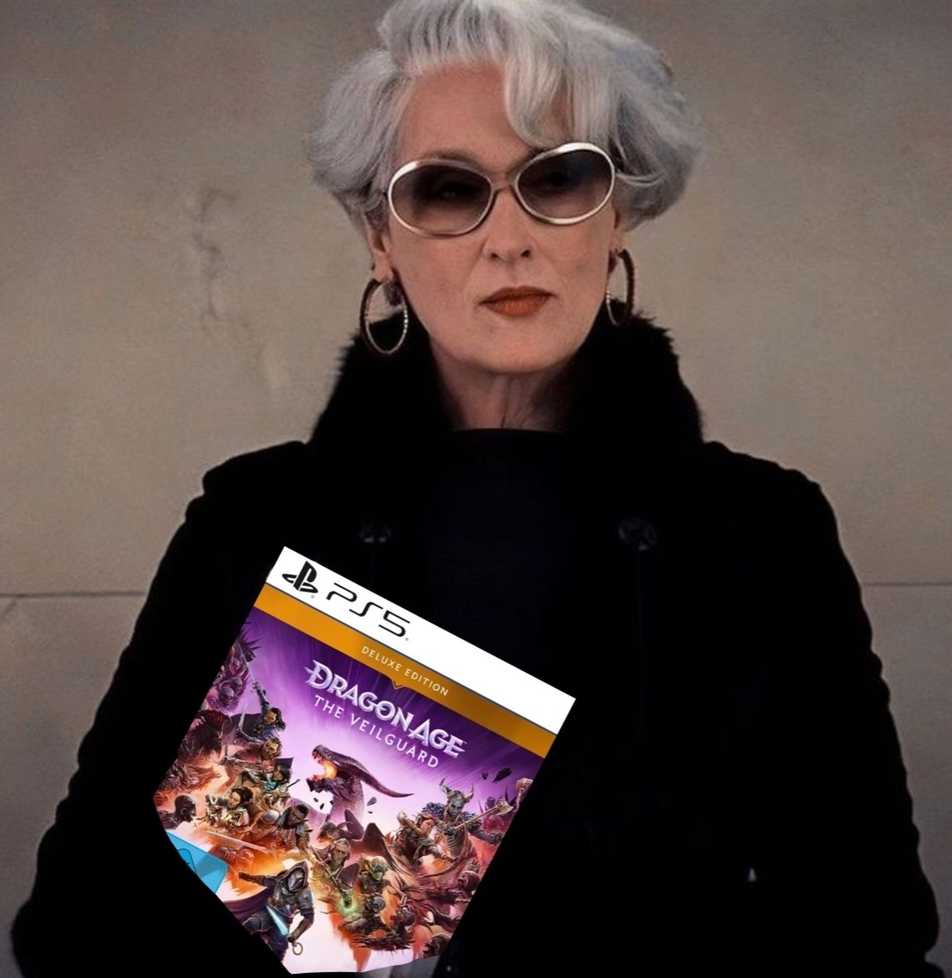 Meryl Streep in 'Devil Wears Prada' holding a physical PS5 copy of Dragon Age: The Veilguard (Deluxe Edition) while looking snatched