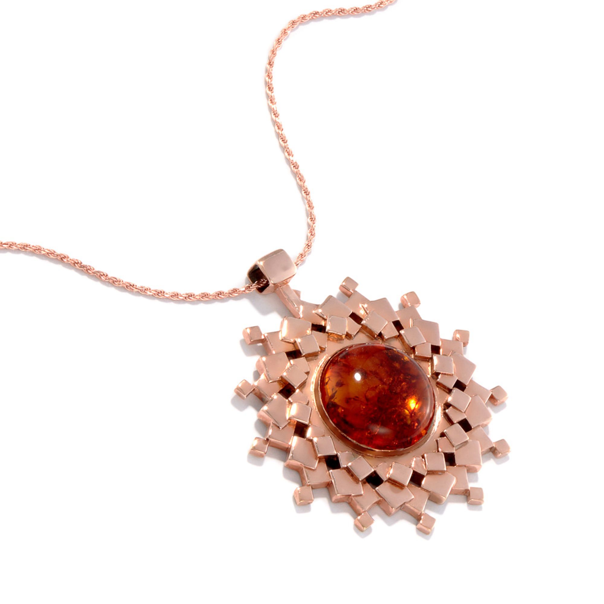 Our sun (or star) amulet. Made entirely of squares, this one is red gold with a Baltic amber center.