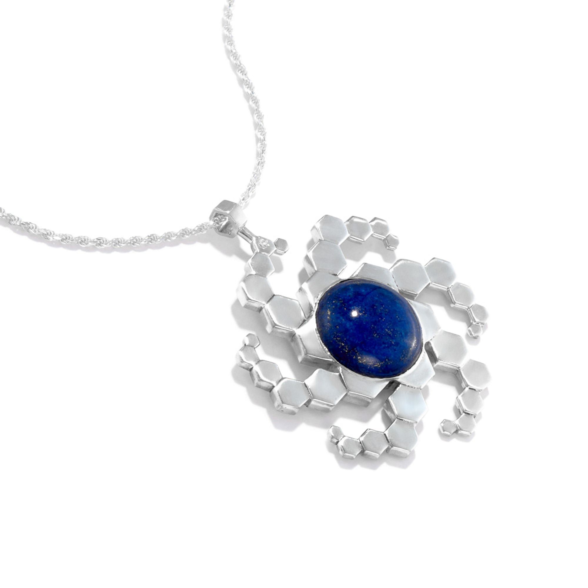 Our Galaxy amulet. This one is a sterling silver spiral galaxy made of six spiral arms of hexagons. In the center is a 20mm lapis lazuli gem.