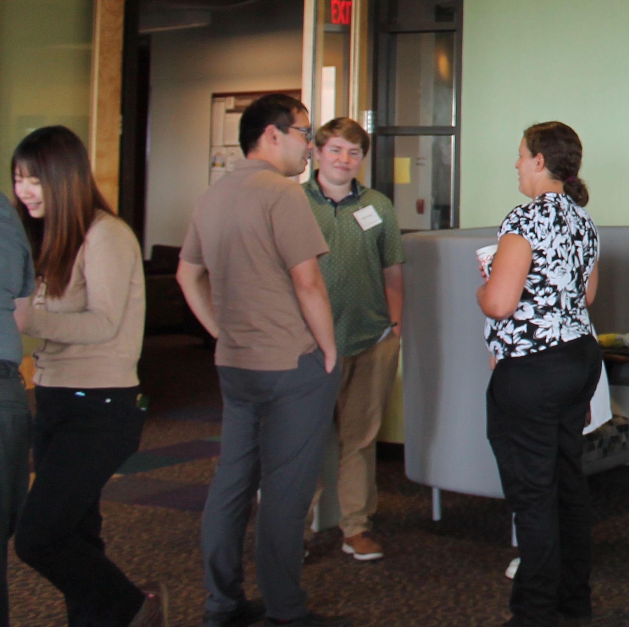 Associate professor Ran Tao chats with new MS students while PhD student Lan Shi (left) smiles at something being shared with another group, at our new student social on August 16, 2024