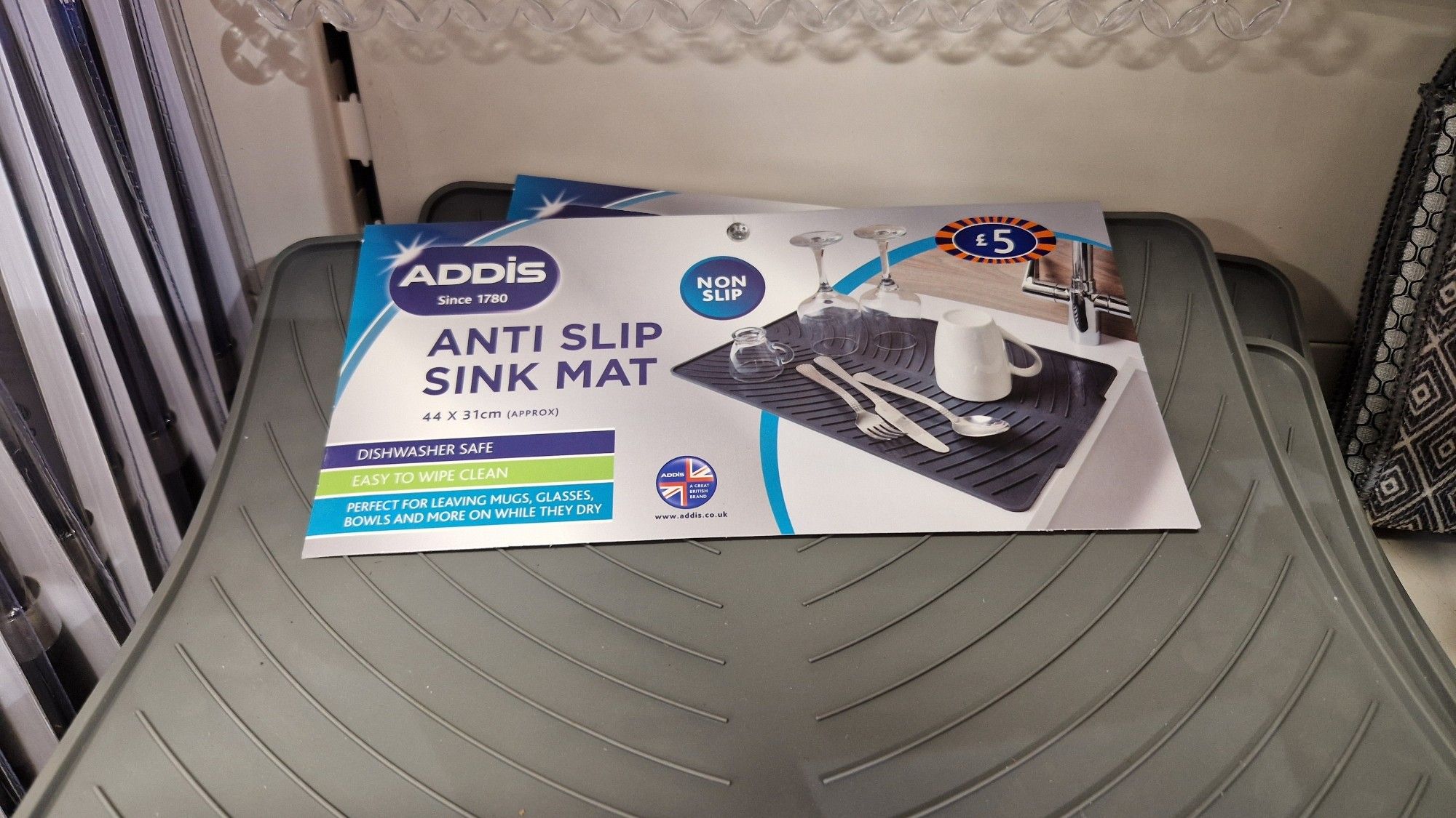 A grey Addis anti slip sink mat that says "anti slip sink mat" in large letters