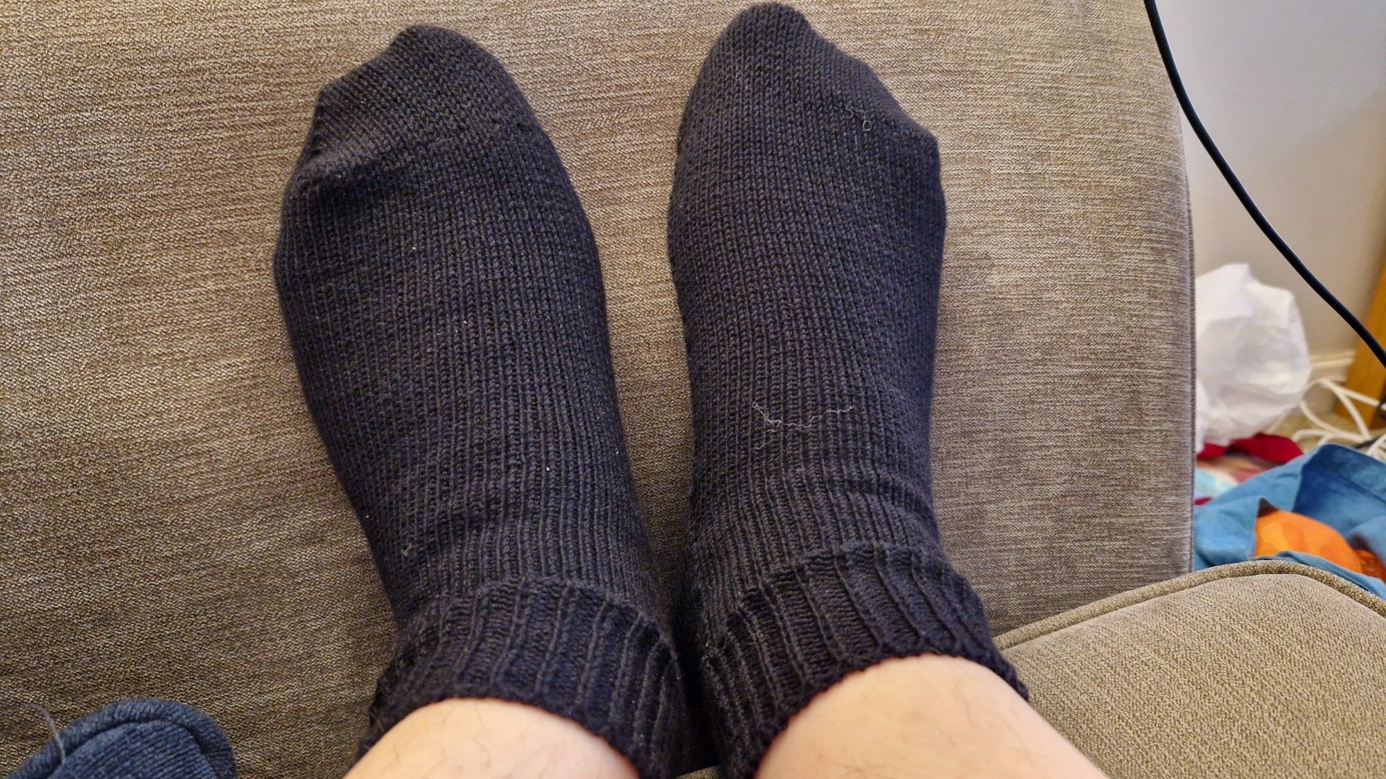 Feet wearing black knitted ankle socks