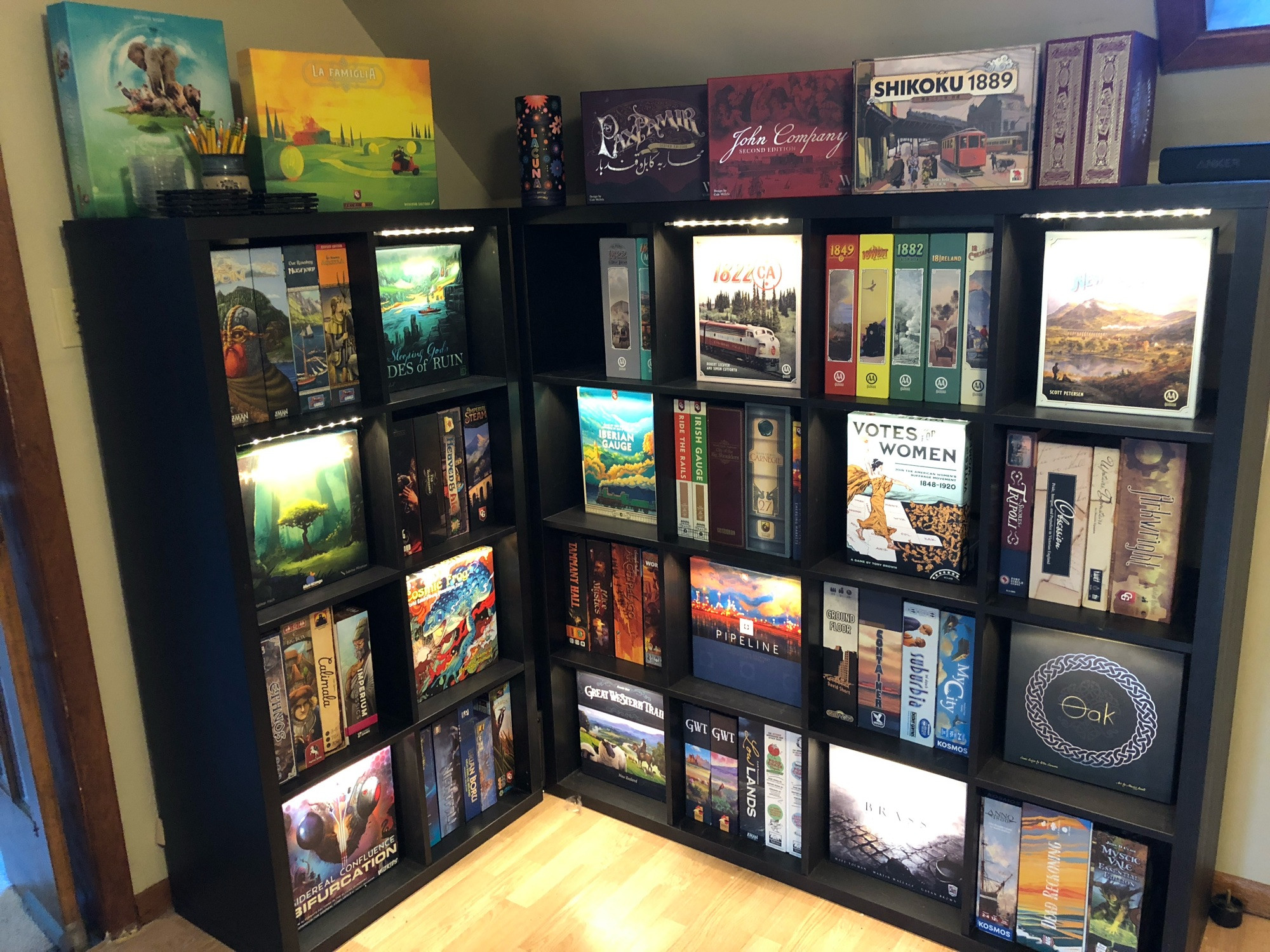 A shelf of board games, some lit up. 