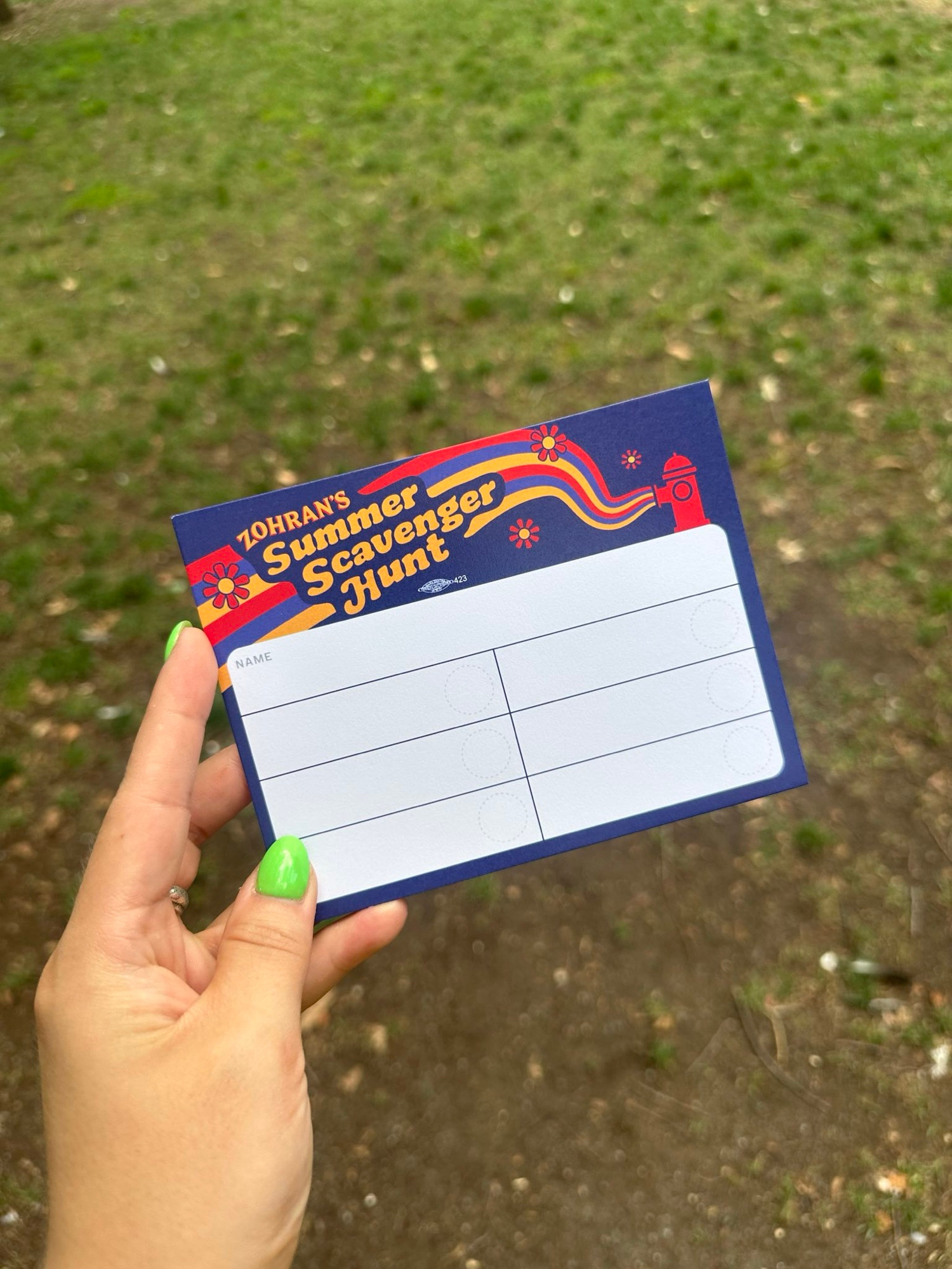 A hand is holding a card that says “Zohran’s Scavenger Hunt” 