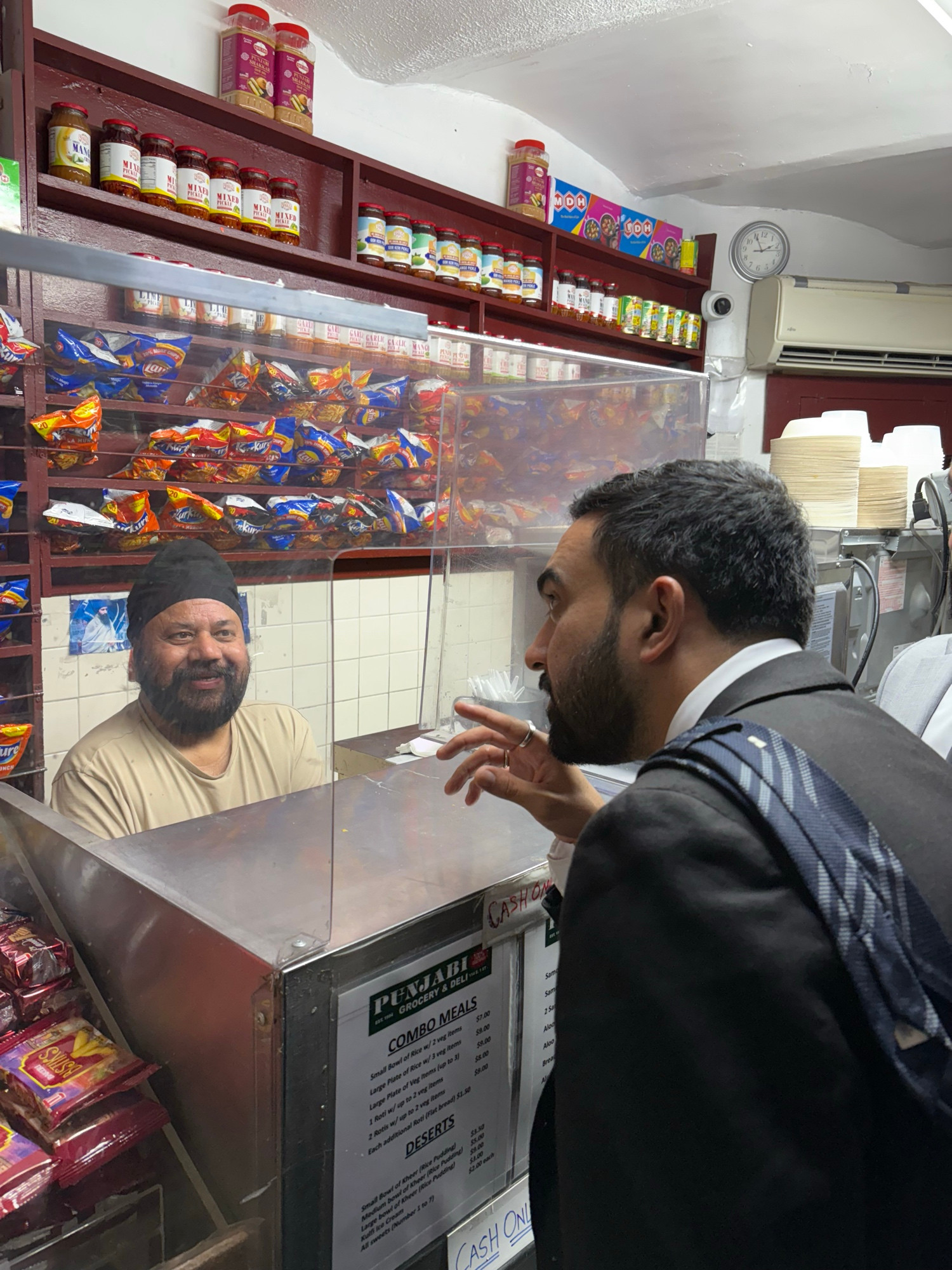 Zohran ordering across a counter. 