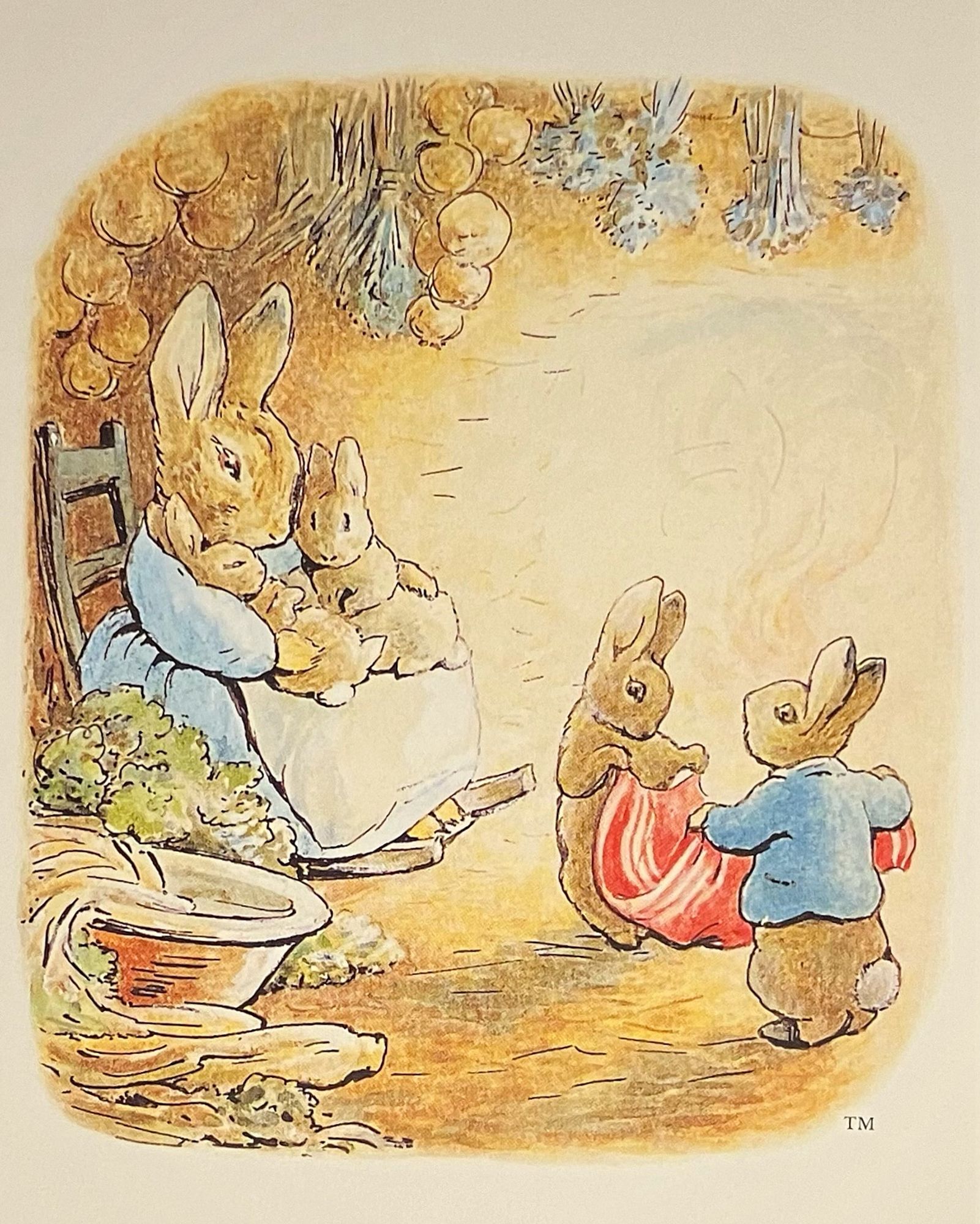 A cozy scene of a mother rabbit in a blue dress and reclined in a rocking chair. In each arm she holds a young bunny and in front of her, two older bunnies are folding a red cloth.