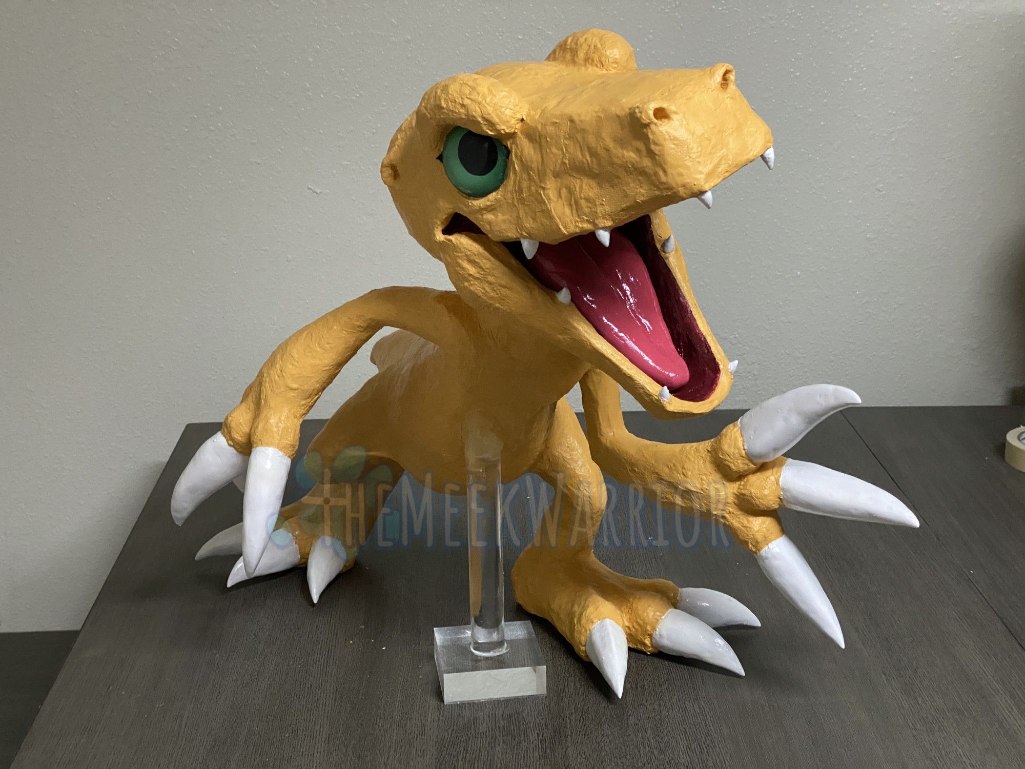 Another angle on Agumon, showing a clear acrylic pillar attached to him for support.